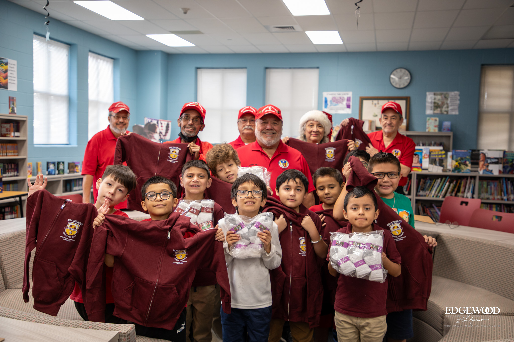 Edgewood Veterans present hoodies to students at RCLS, in school colors with the school logo on them. Students also received new socks. 