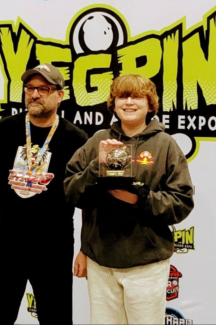 Picture  of Sterling with Yegrin International Pinball Championship trophy