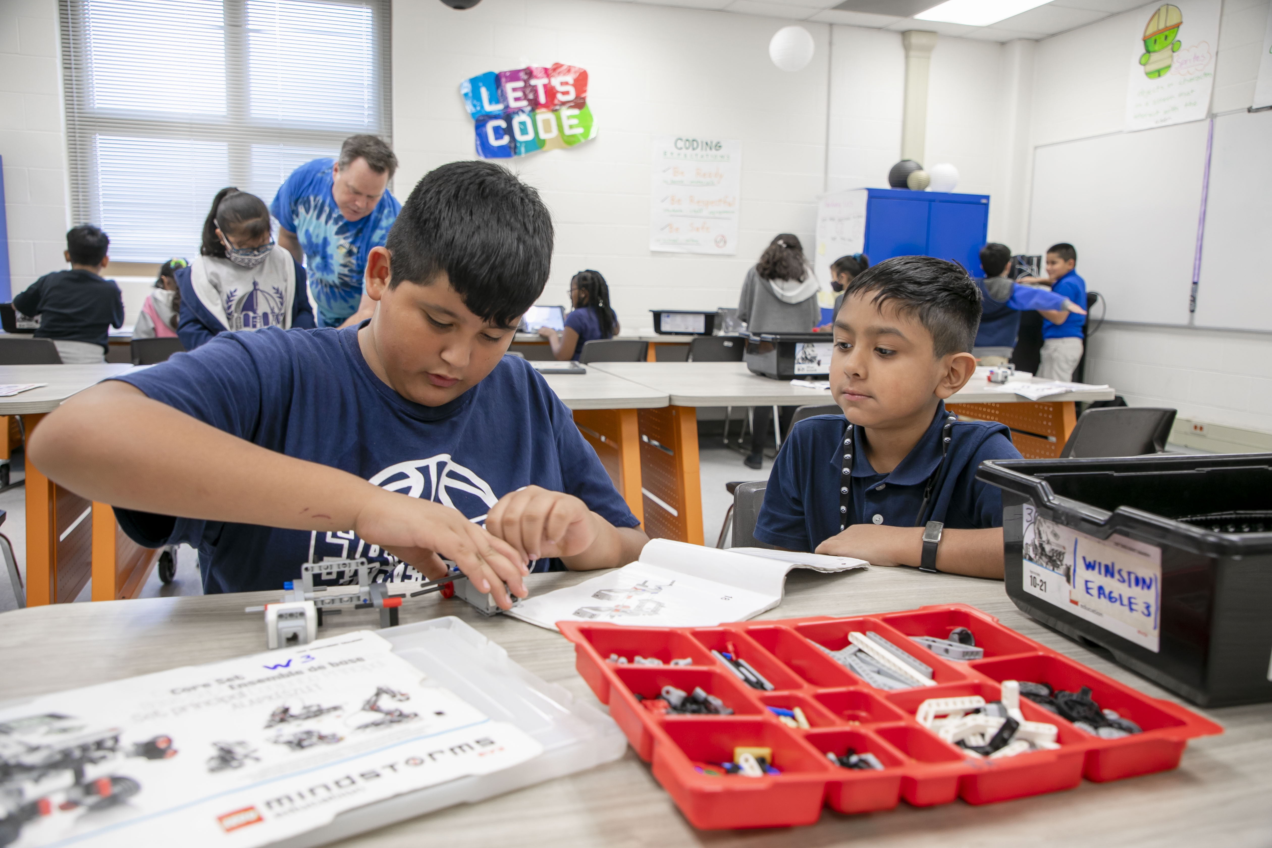 two students building robots