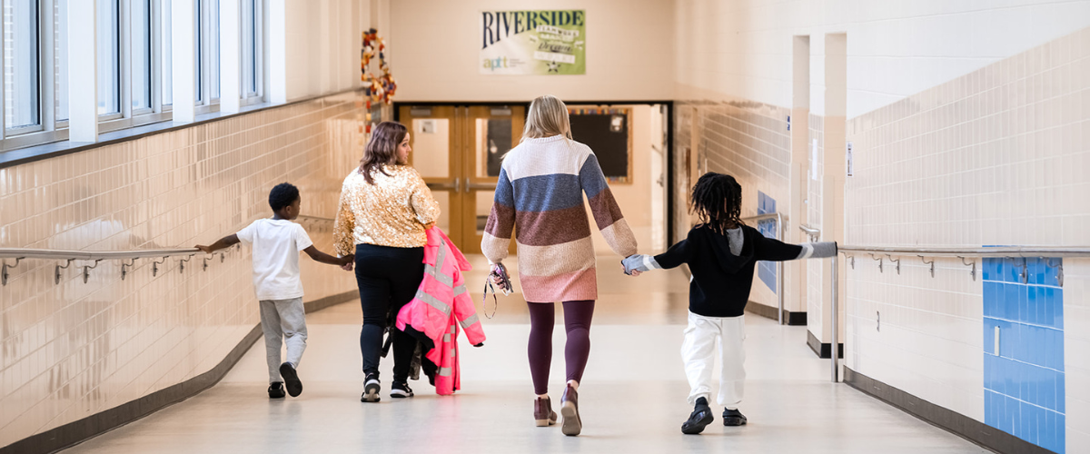 students and principal walking down the hall