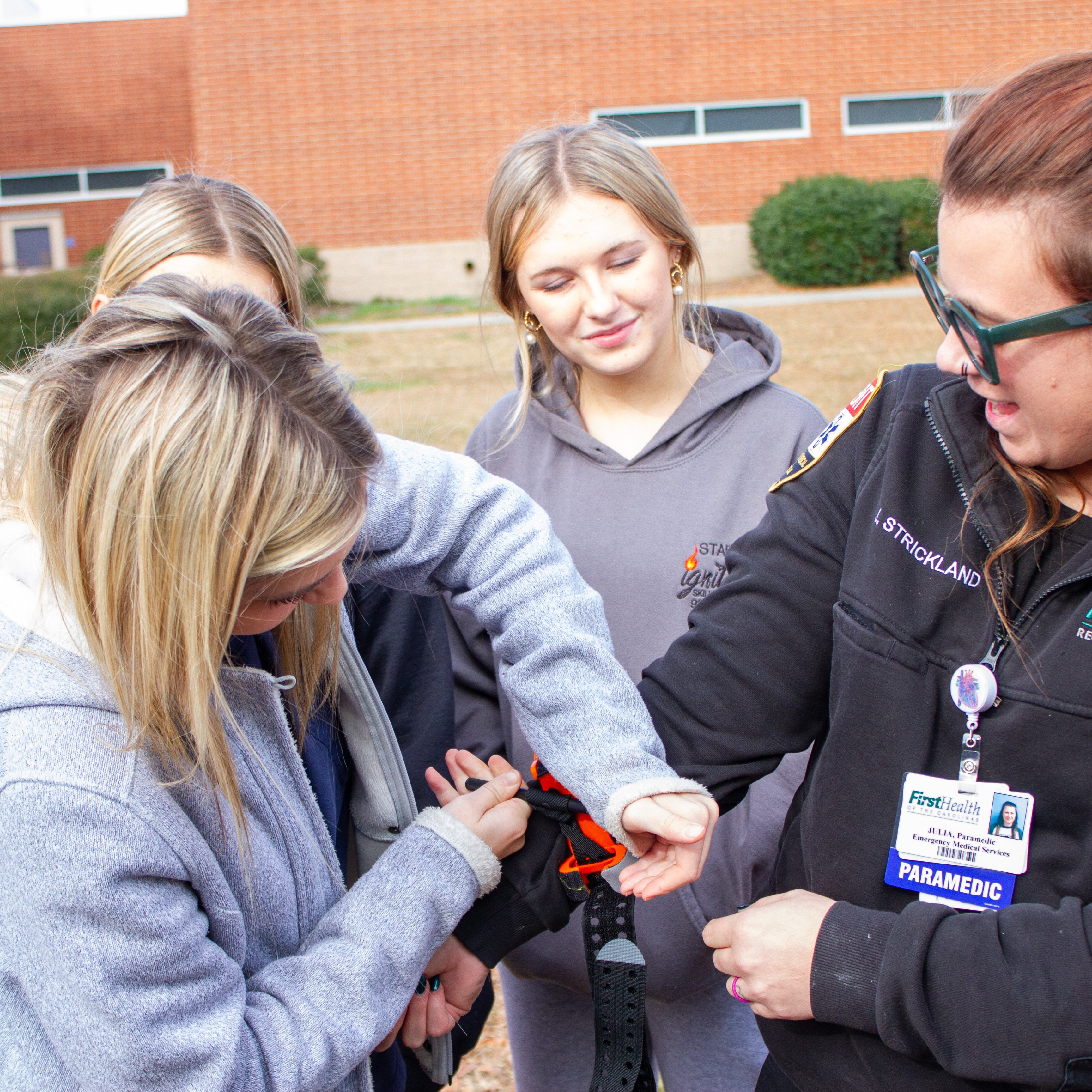 Academy of Health Sciences students at SLHS get hands on experience with tourniquets while FirstHealth Paramedics visit their classes.
