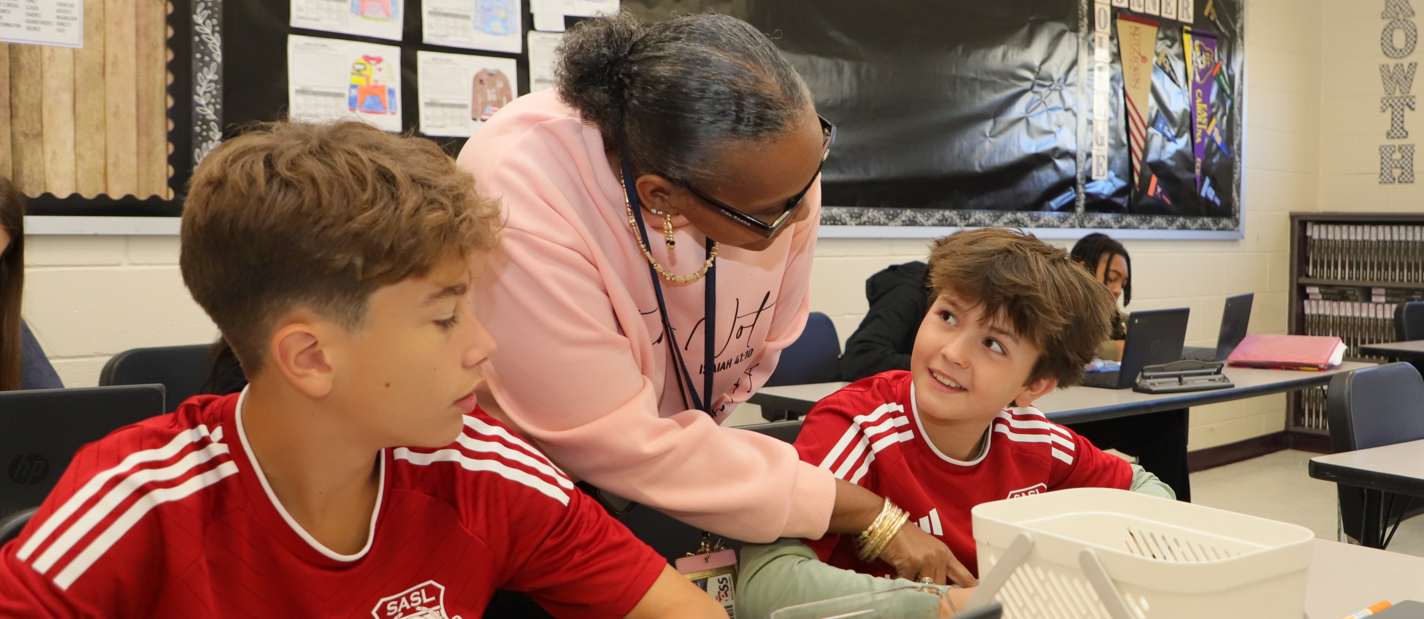 Teacher works with a Middle School Student