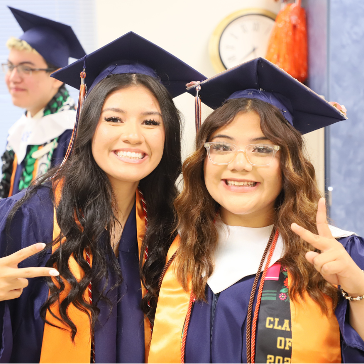 Students getting ready for graduation in cap and gown