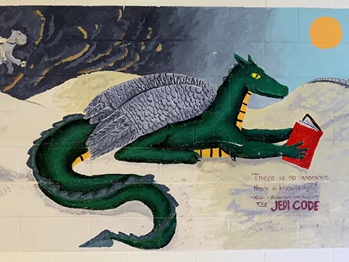 dragon reading a red book