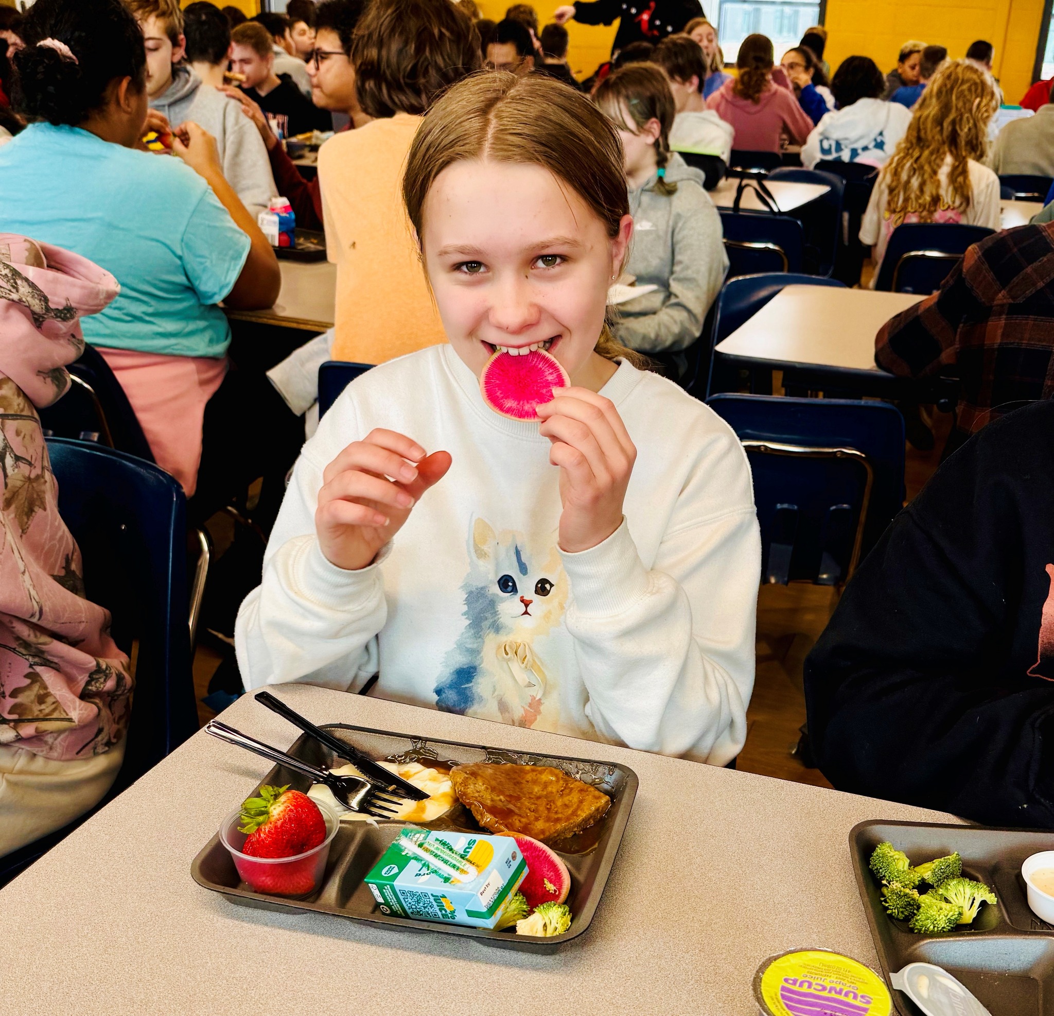 girl trying watermelon radish