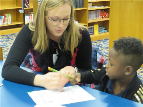 Student and teacher working together on a paper