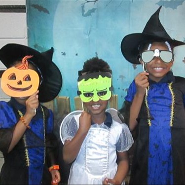 students dressed and holding masks