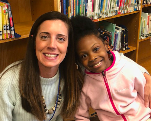 student and school staff smiling for a picture