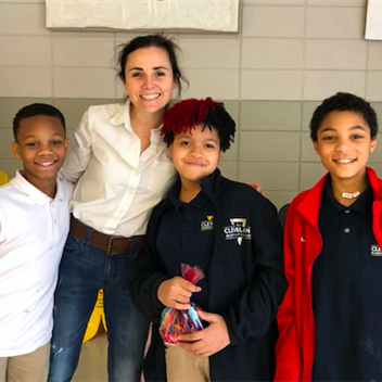 students and school staff smiling for a picture