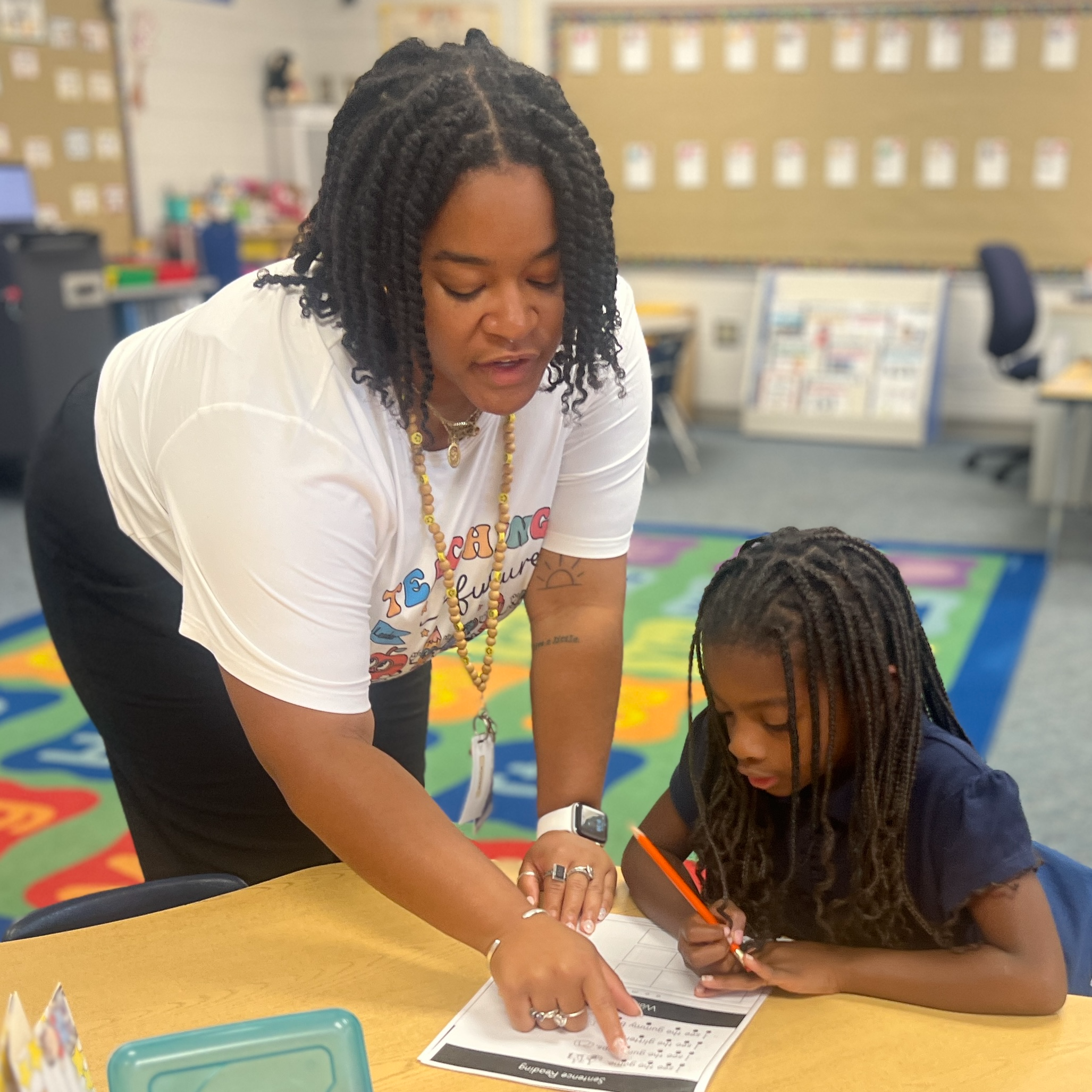 teacher helping student who is drawing