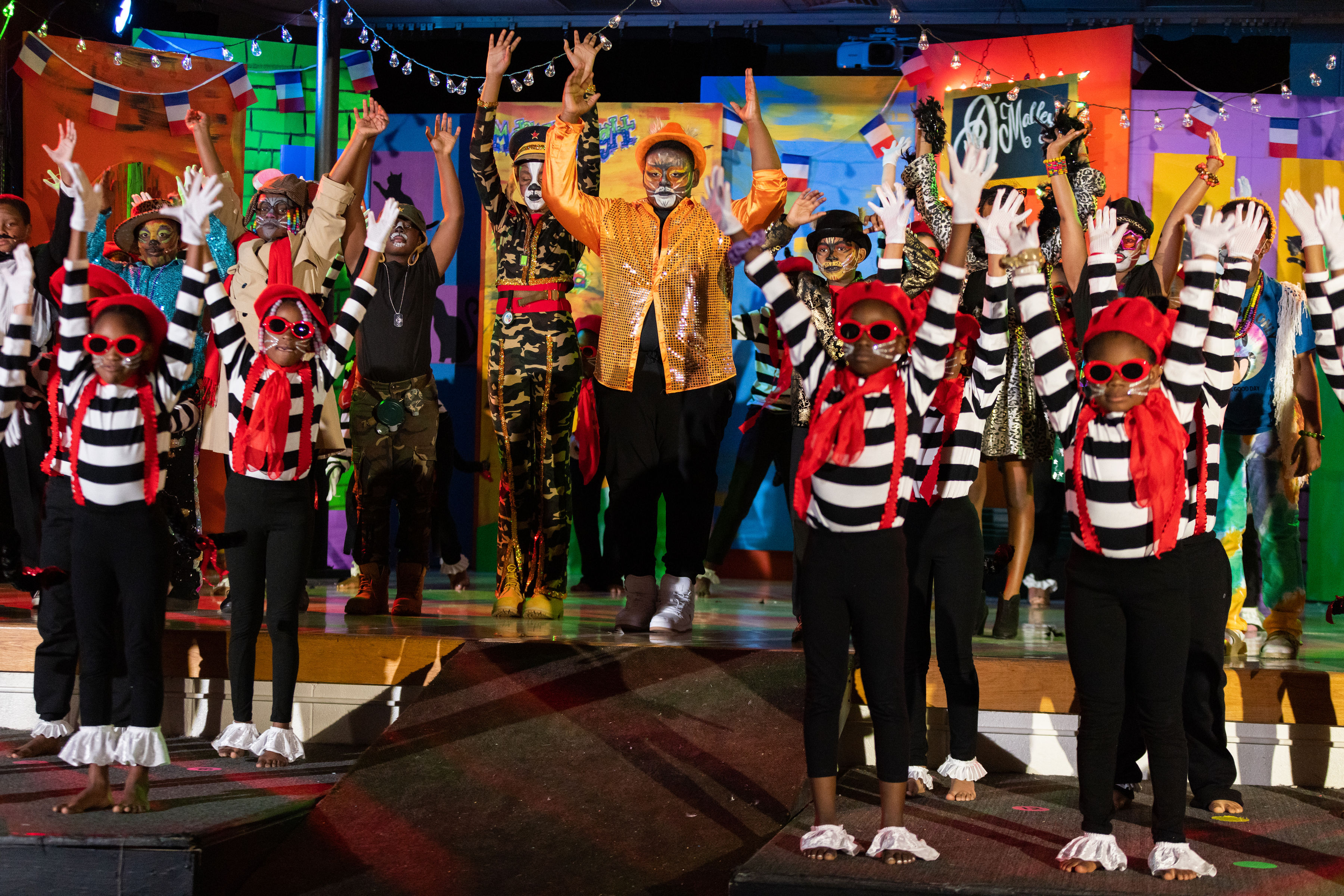 students in costume on stage