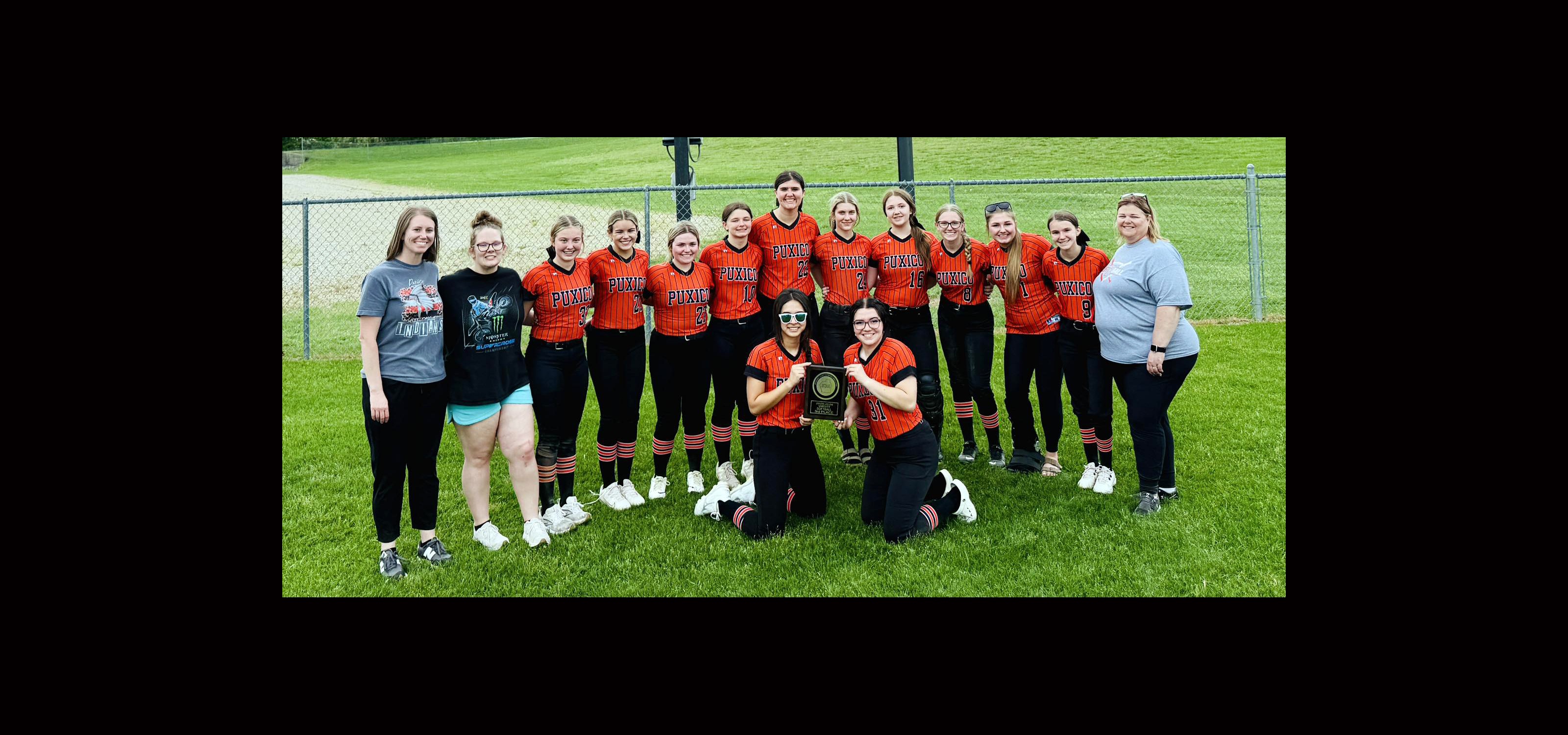 Lady Indians softball team with trophy