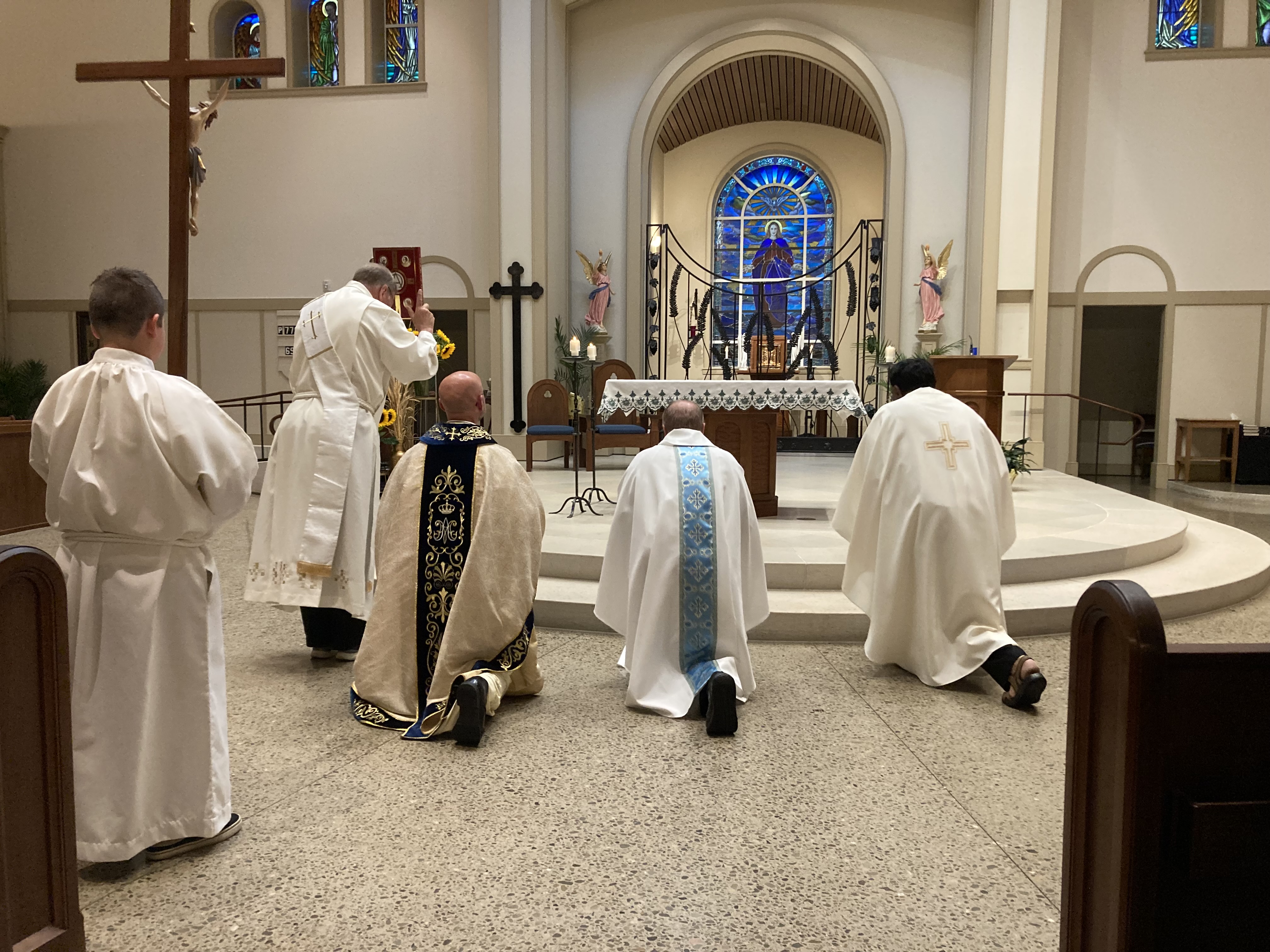 clergy bowing before the altar at St.. Mary's