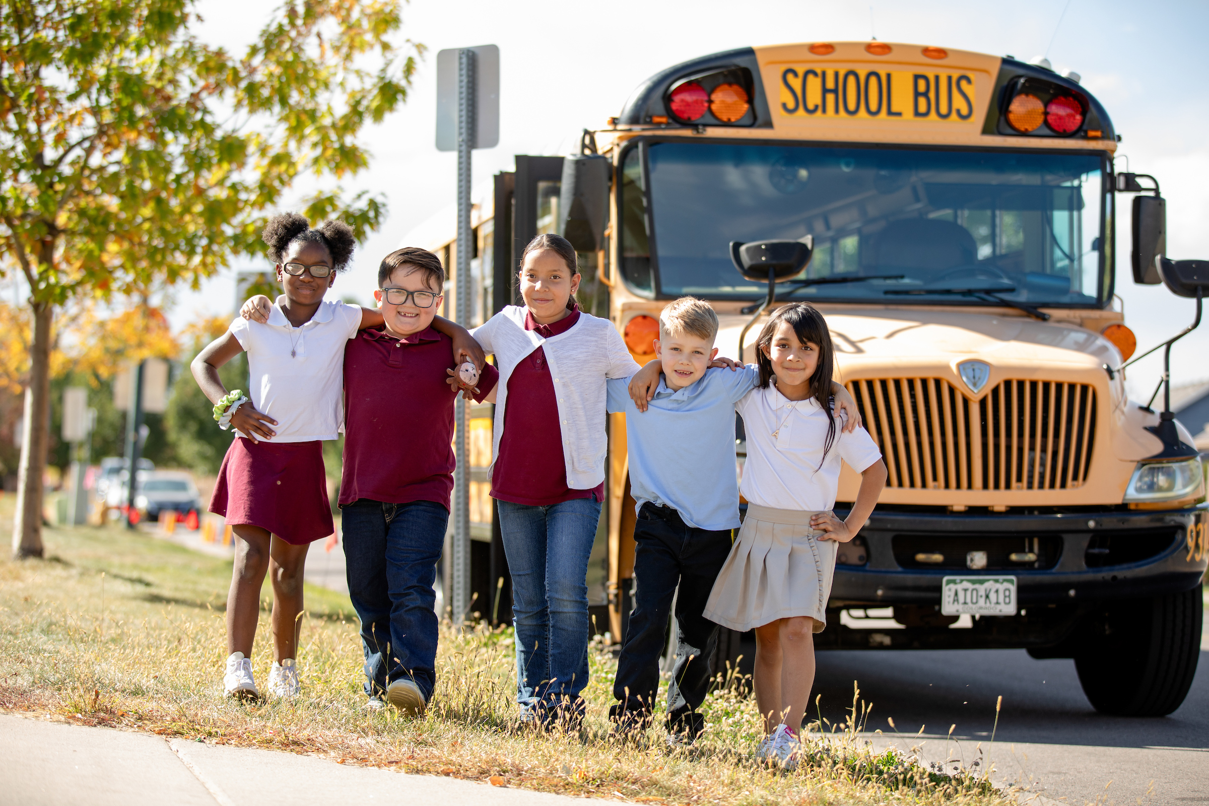 photo of students standing in front of school bus