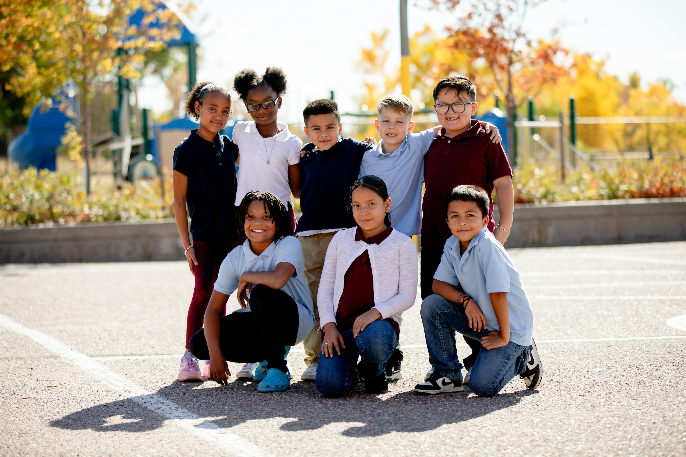 group of students on playground posing for photo