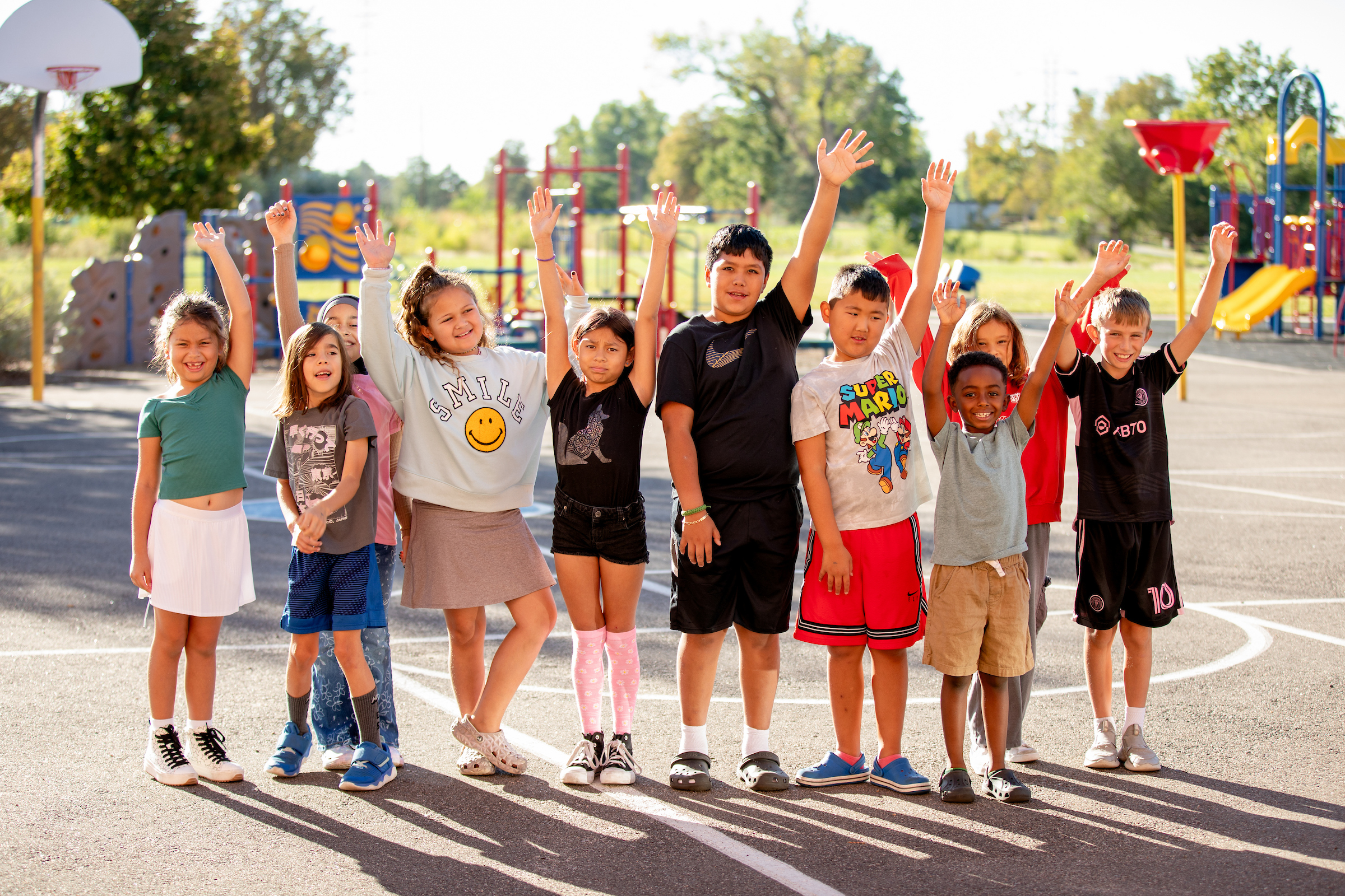 group of students with arms around each other on a playground