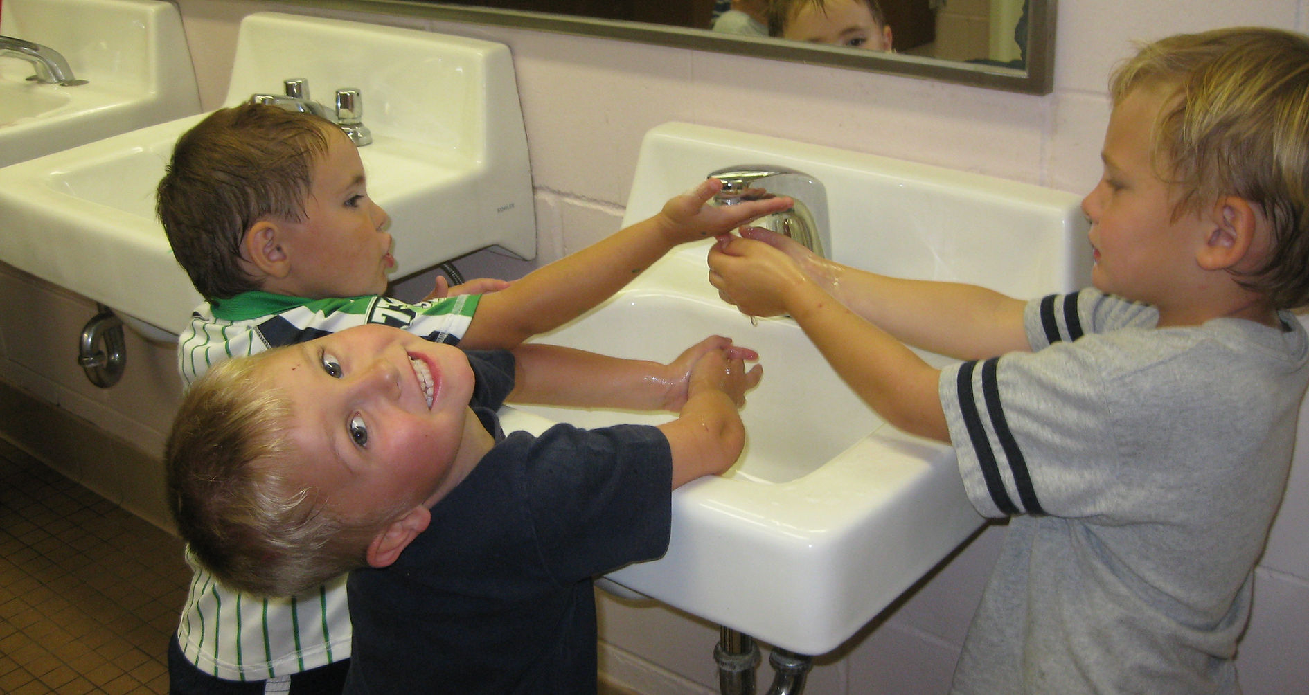 students washing their hands