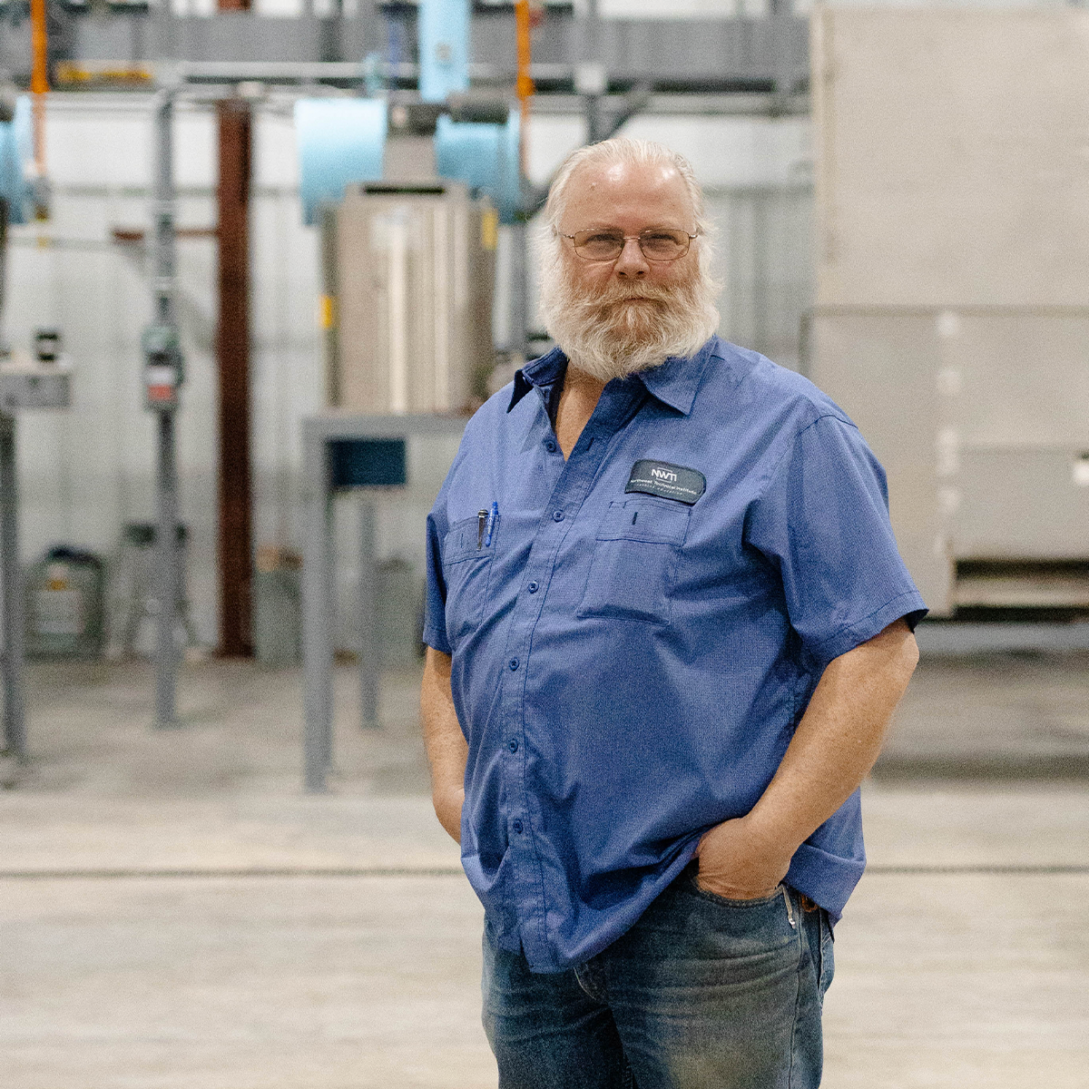 PHOTO:  Michel Lingerfelt smiling in front of ammonia refrigeration system