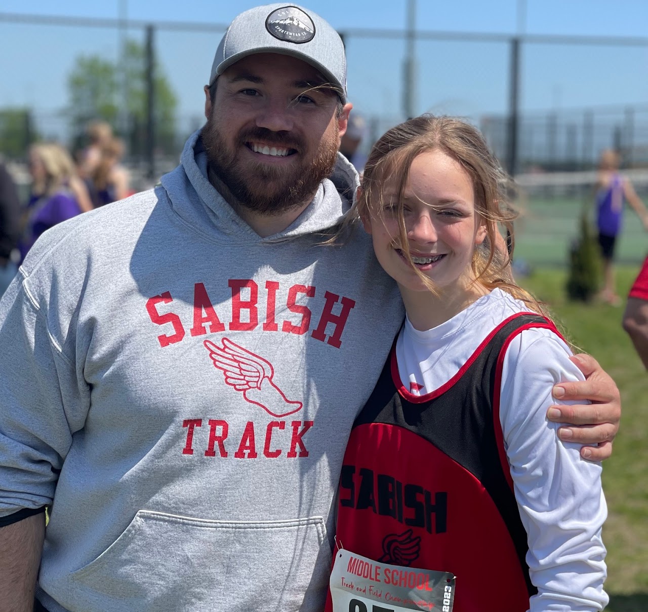 student and coach smiling