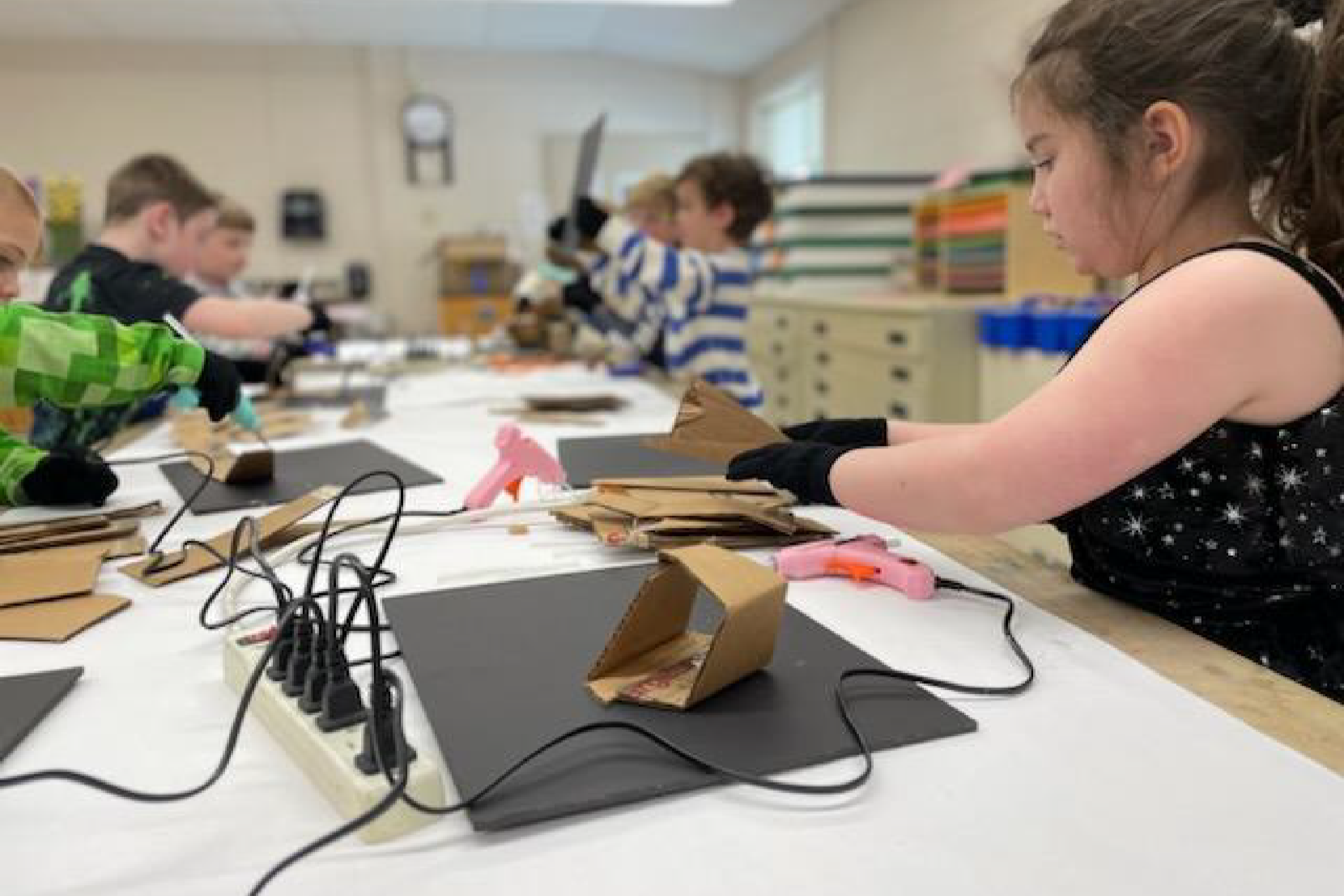 kids creating art with cardboard