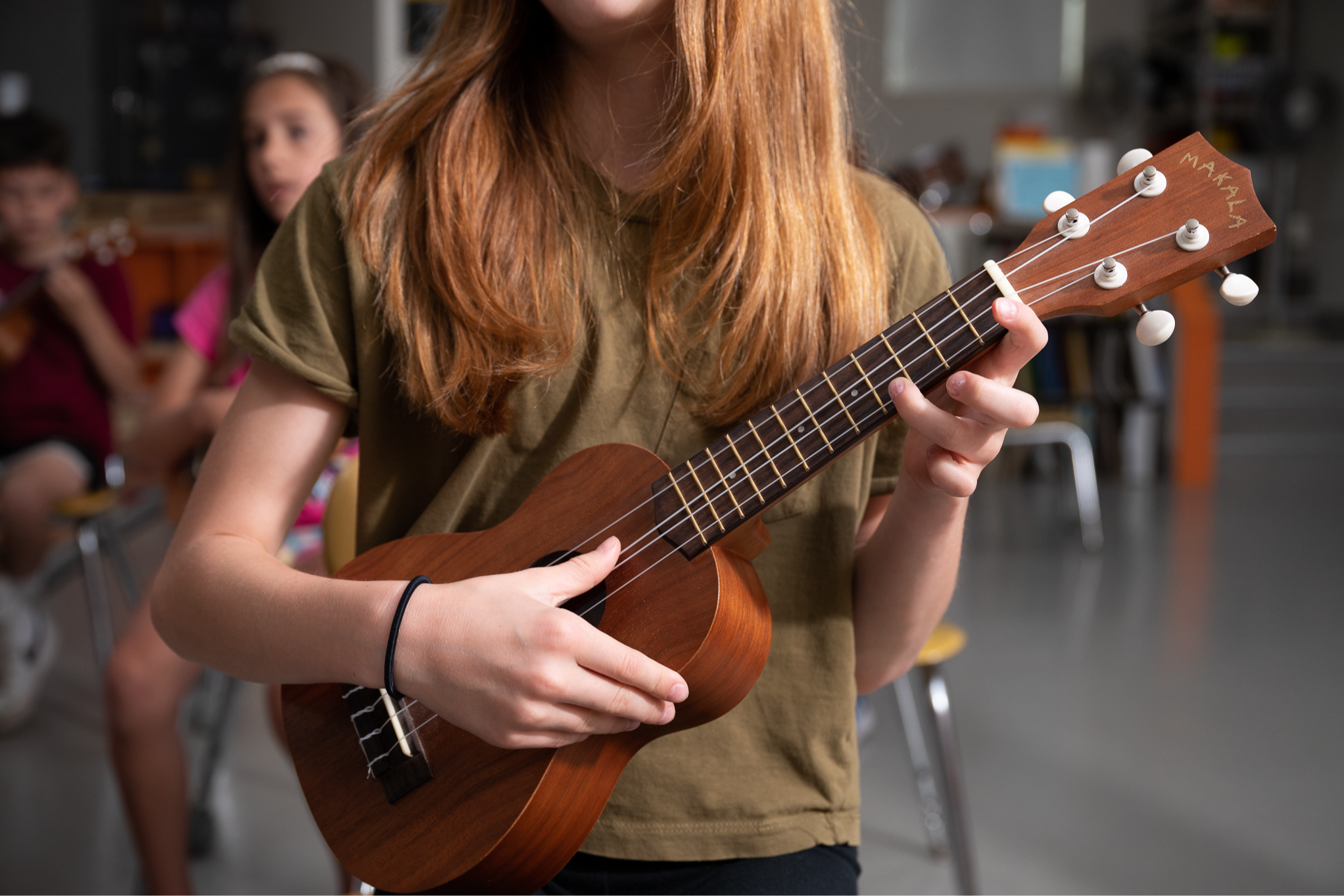 girl holding ukelele