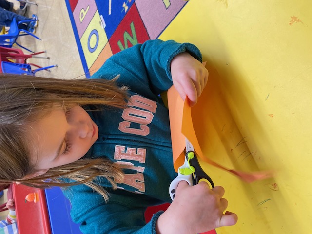 girl cutting with scissors