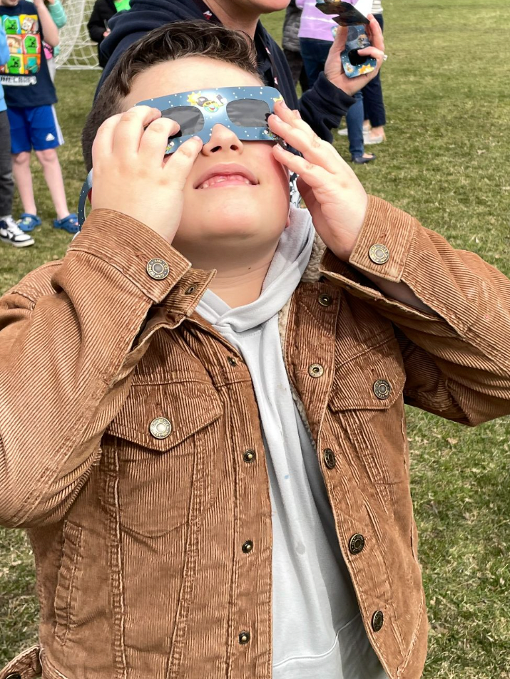 kid wearing eclipse glasses