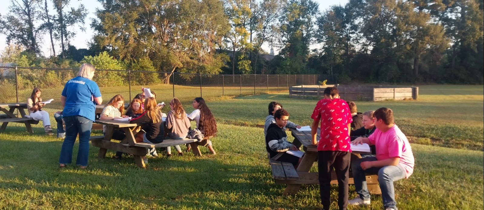 students reading outdoors