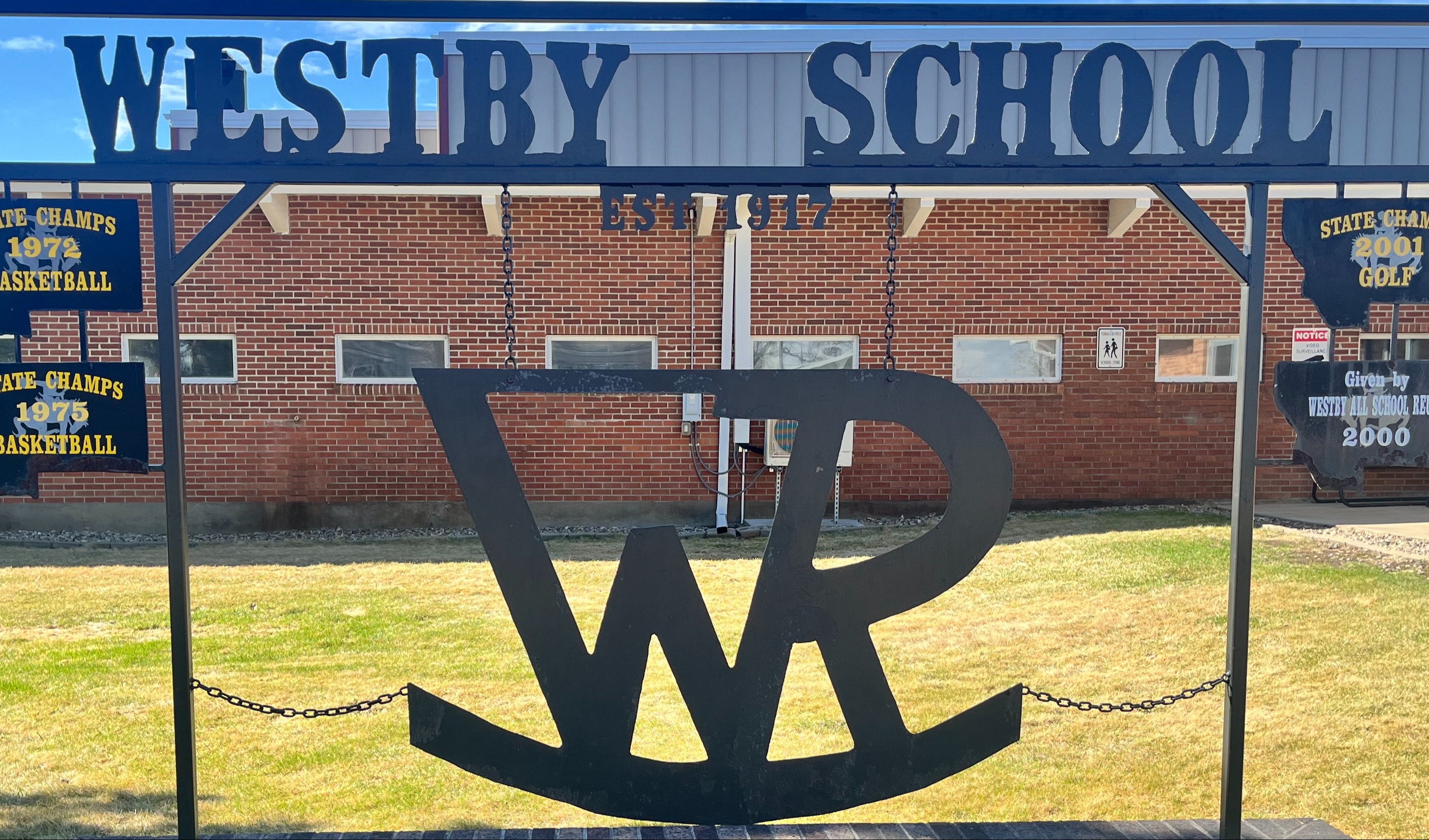 Sign in the front of the school with westby logo that says westby school