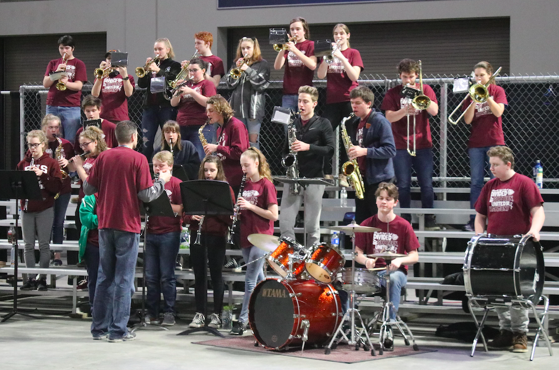 Photo of the members of the PEP Band practicing with the director.