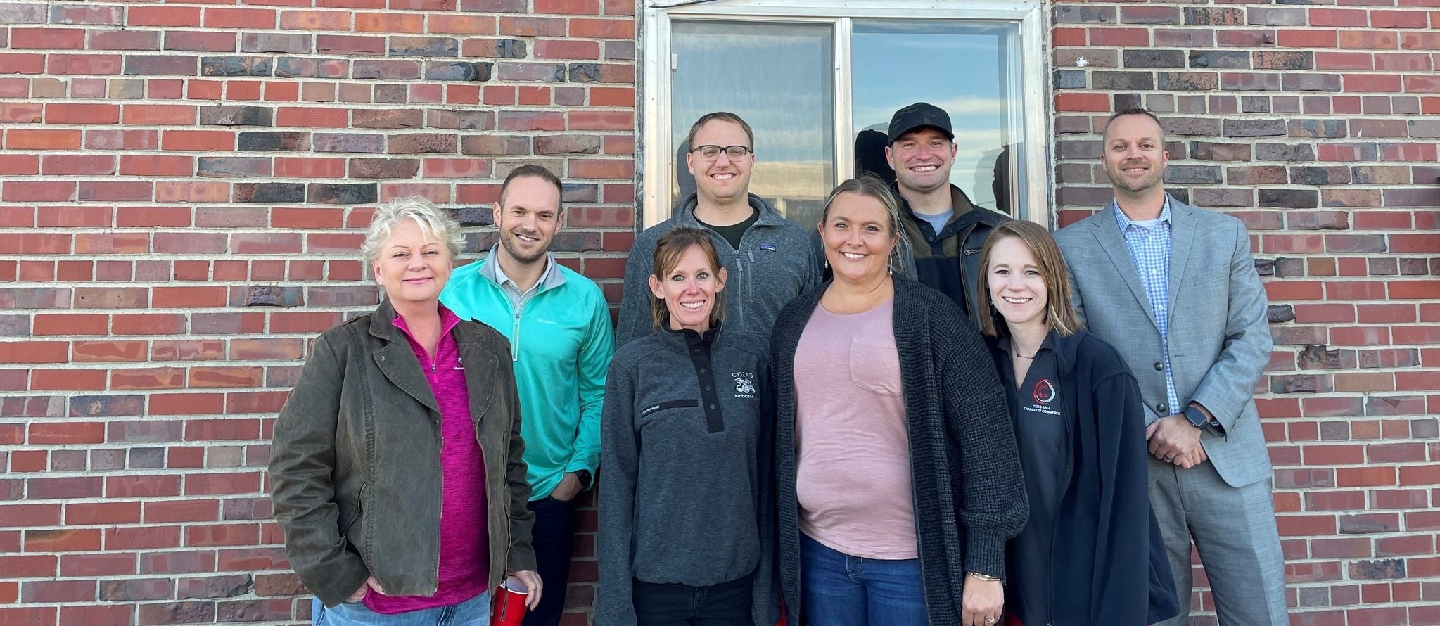 Chamber Members: Shari Rosno, Micah Neill, Wilson Hupp, Kristen Bennett, Mandy Swanson, Jared Crick, Jordan Starman and Tim Sladek in front of the new Chamber Sign. 