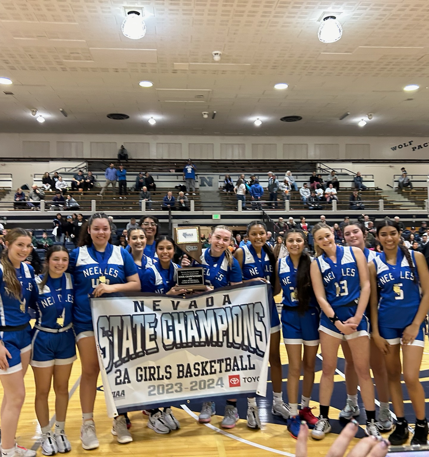 Girls holding state championship banner.