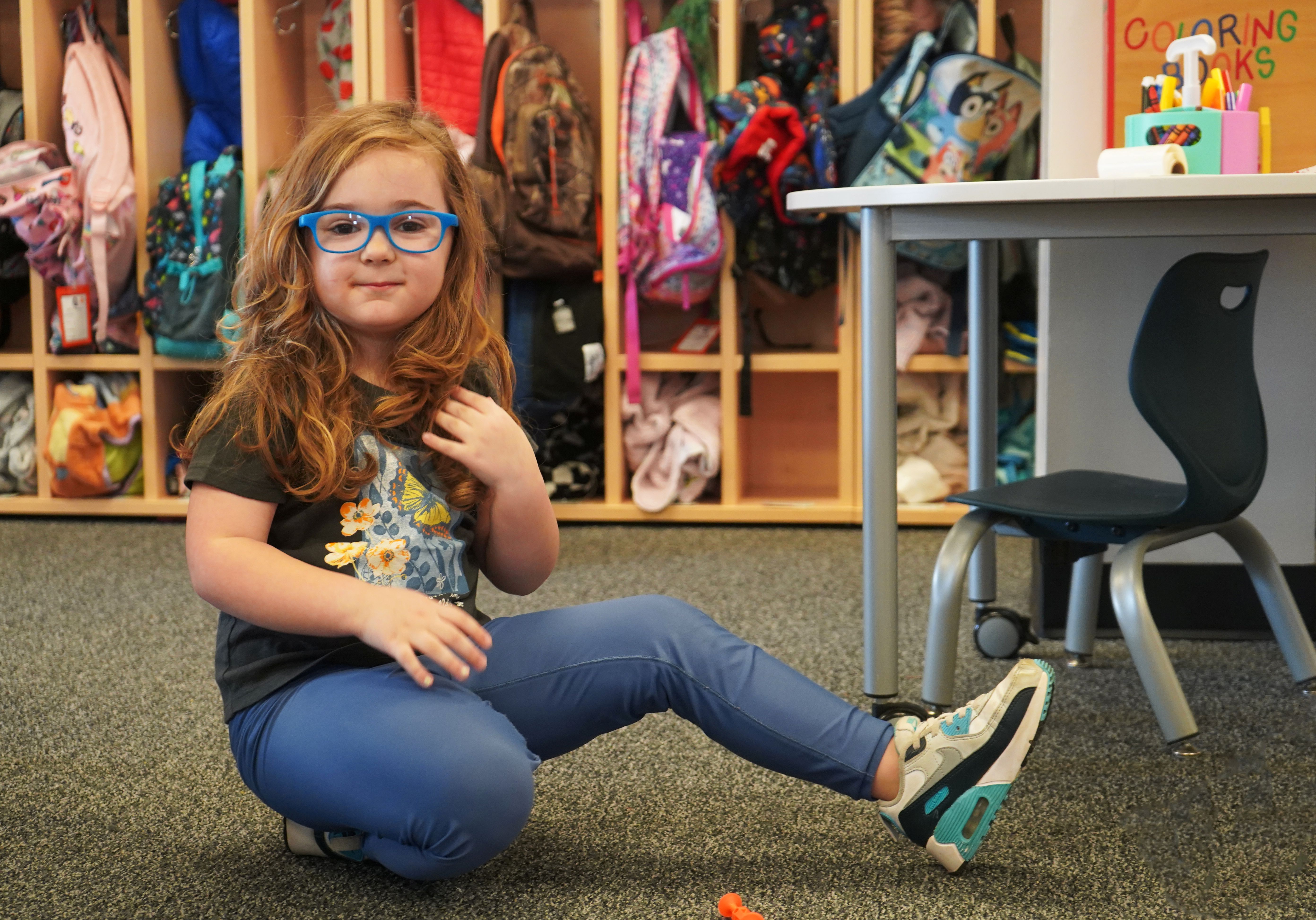 UPK student plays on classroom floor.