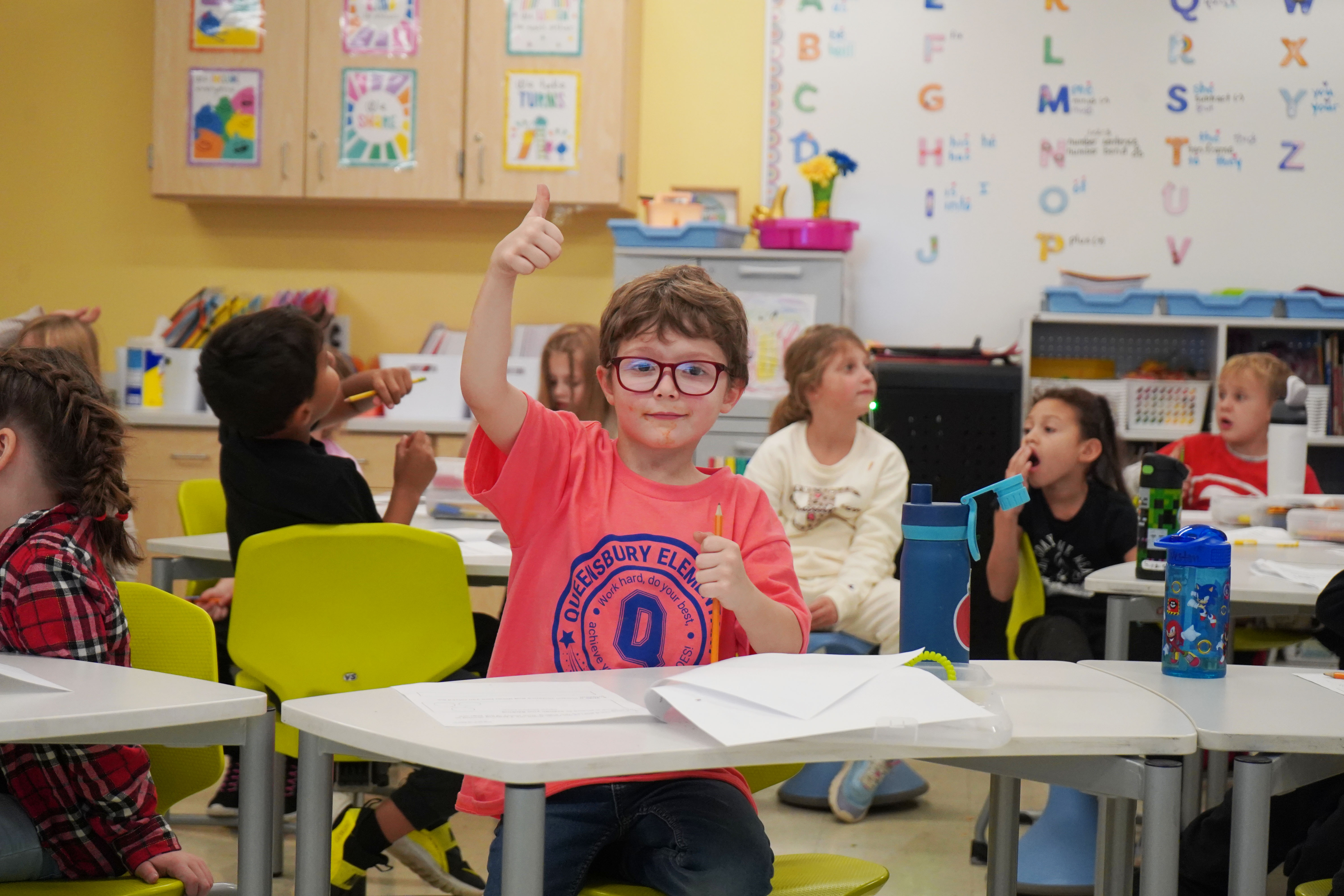 Student gives a thumbs up at QES.