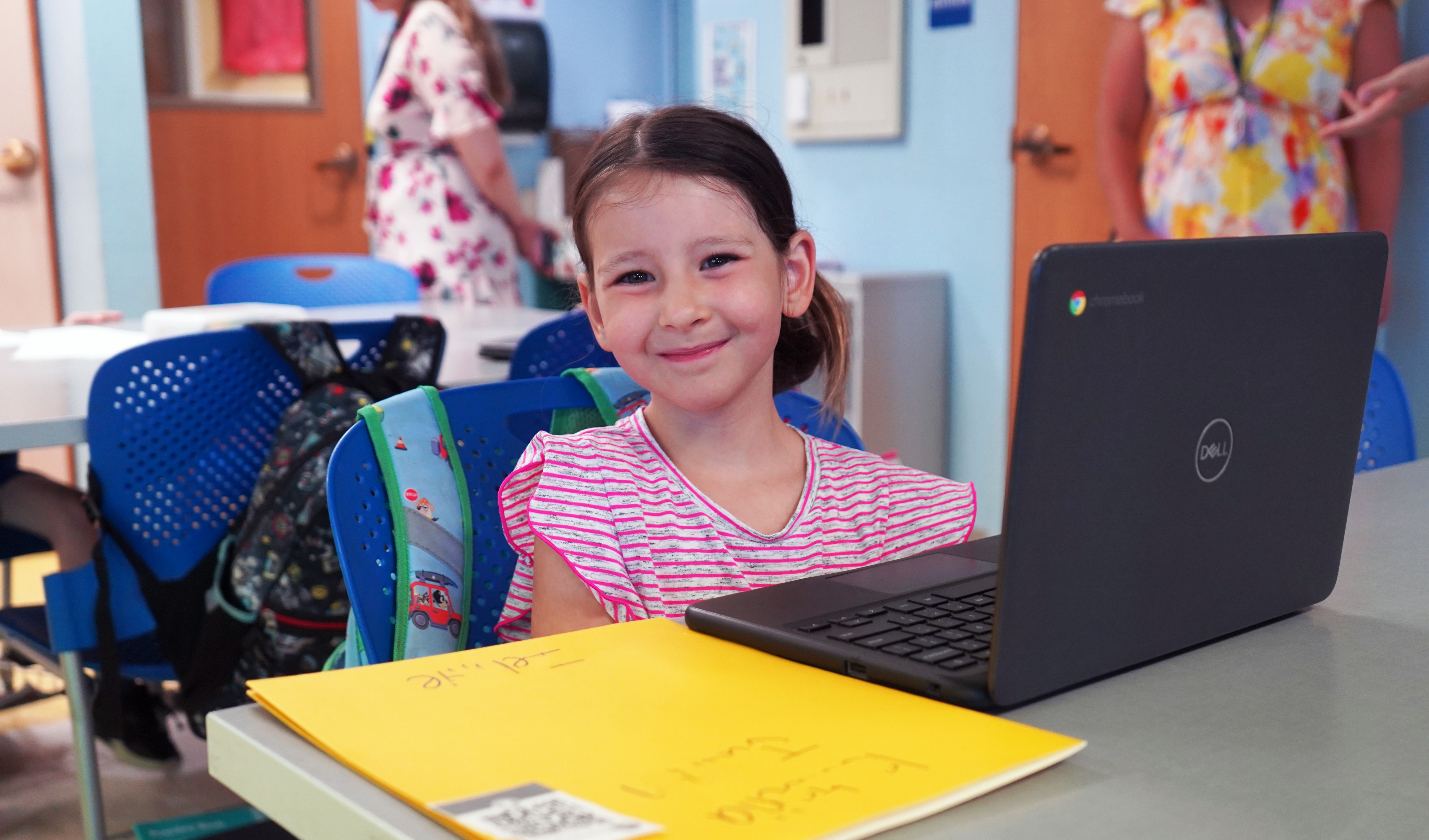 Student sits at desk with Chromebook.