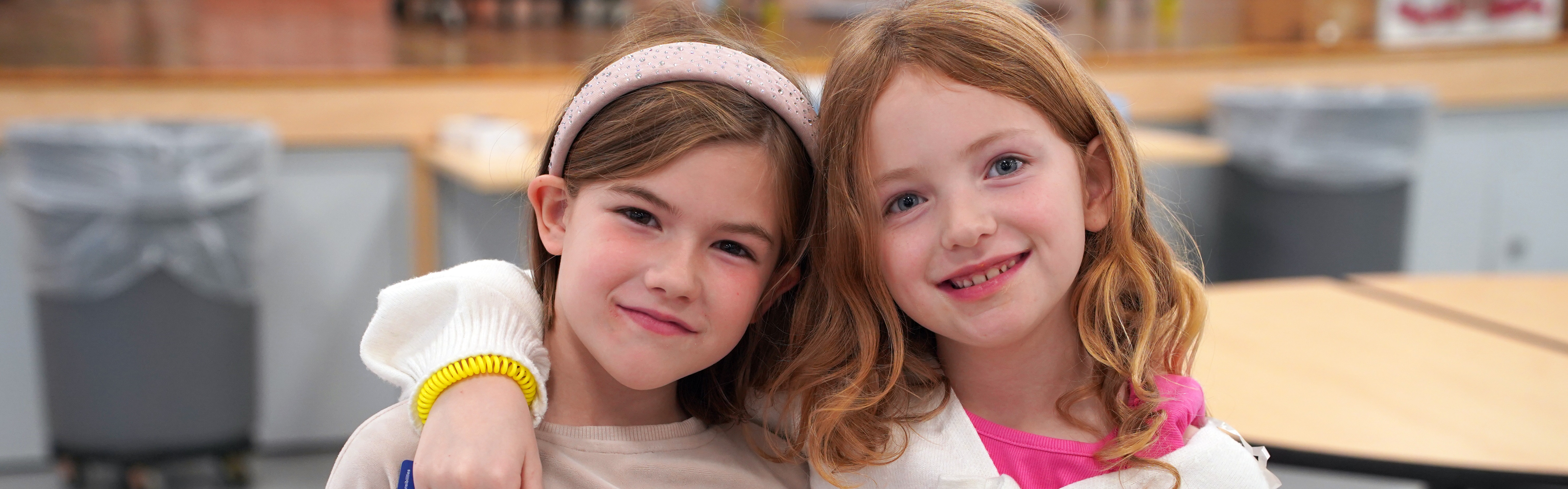 Two students pose in the school cafeteria.