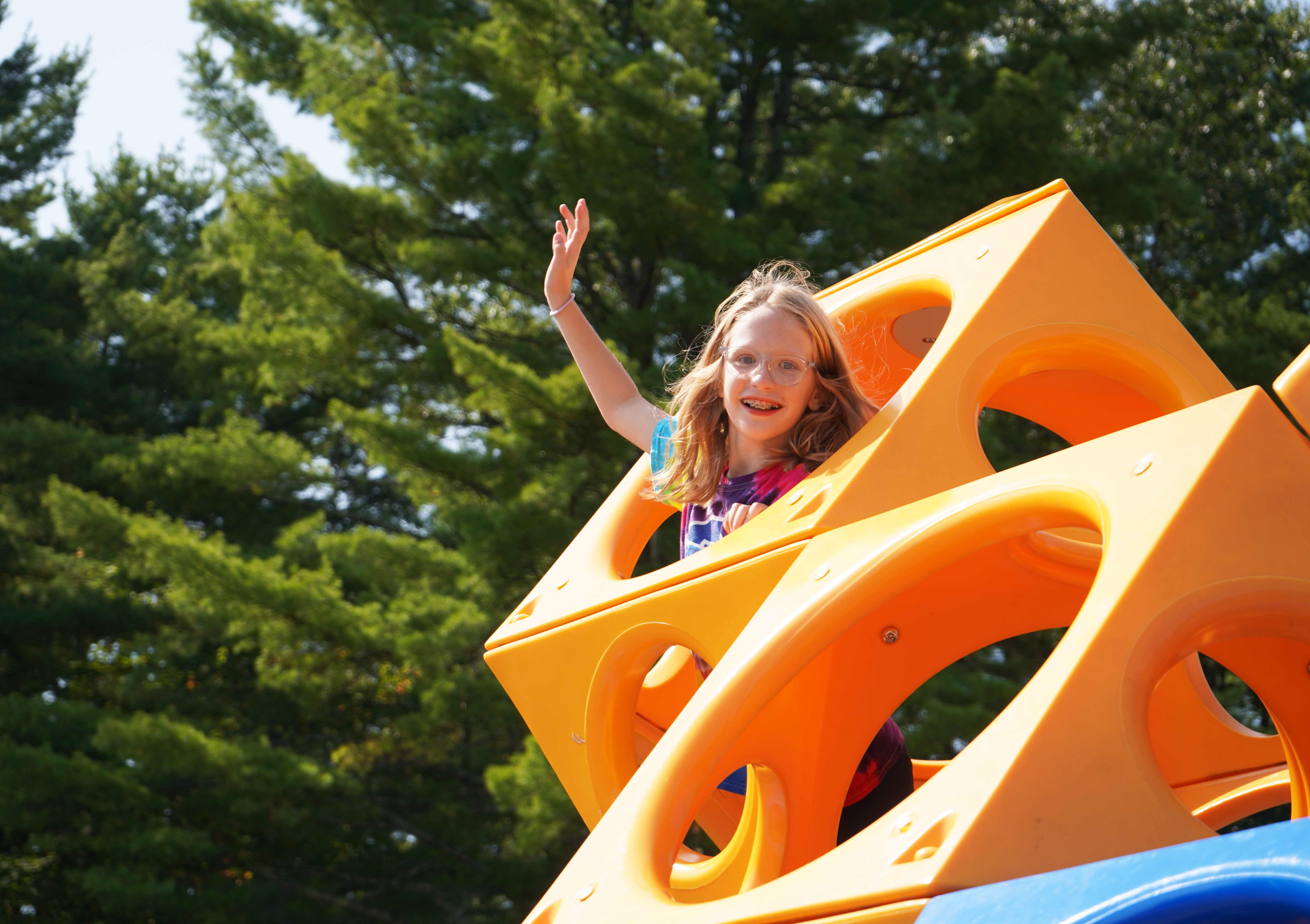 Student plays on playground equipment.