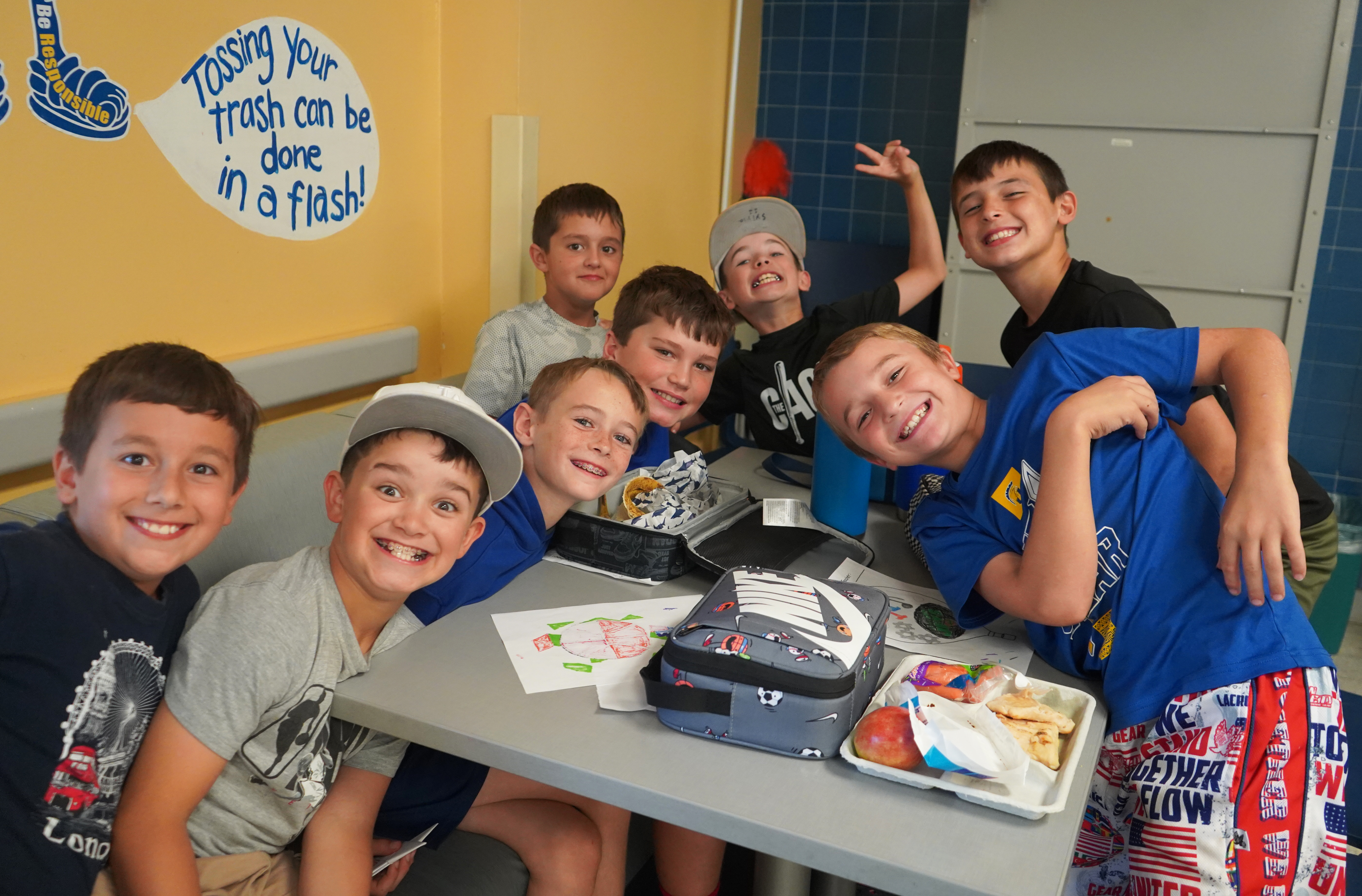 Students each lunch together in school cafeteria.