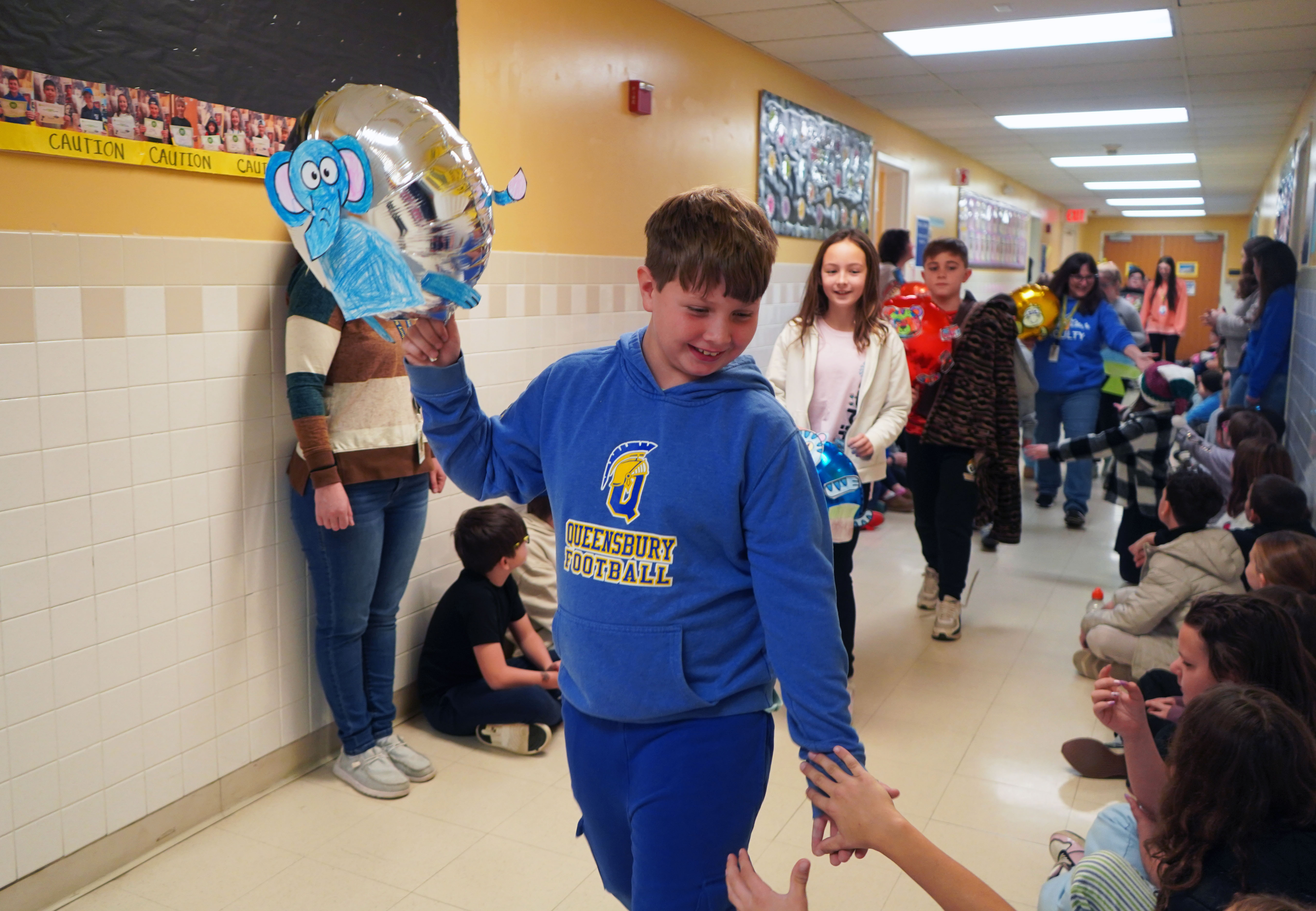 Student participates in balloon parade.