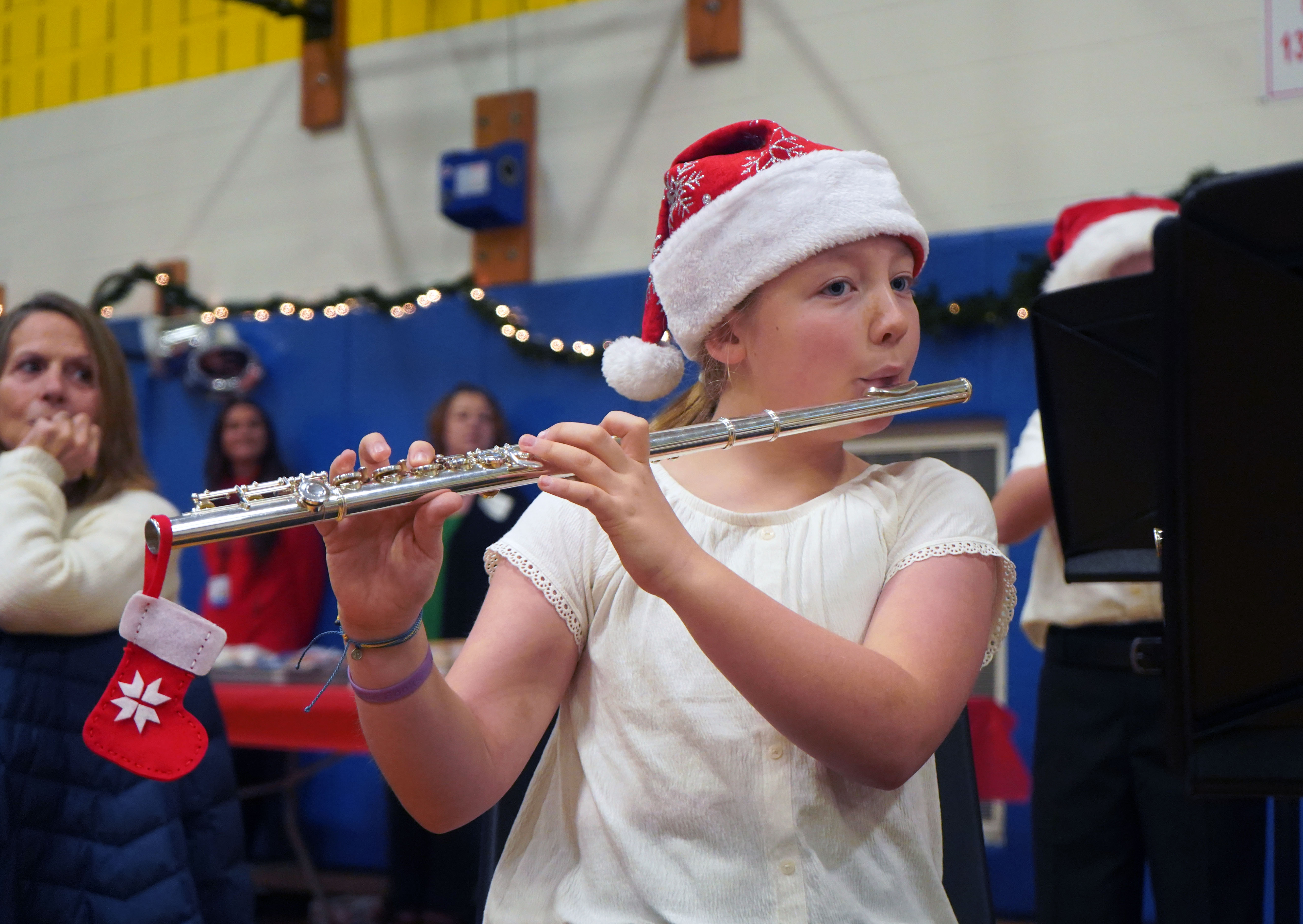 Student plays the flute at Grandparents Breakfast.