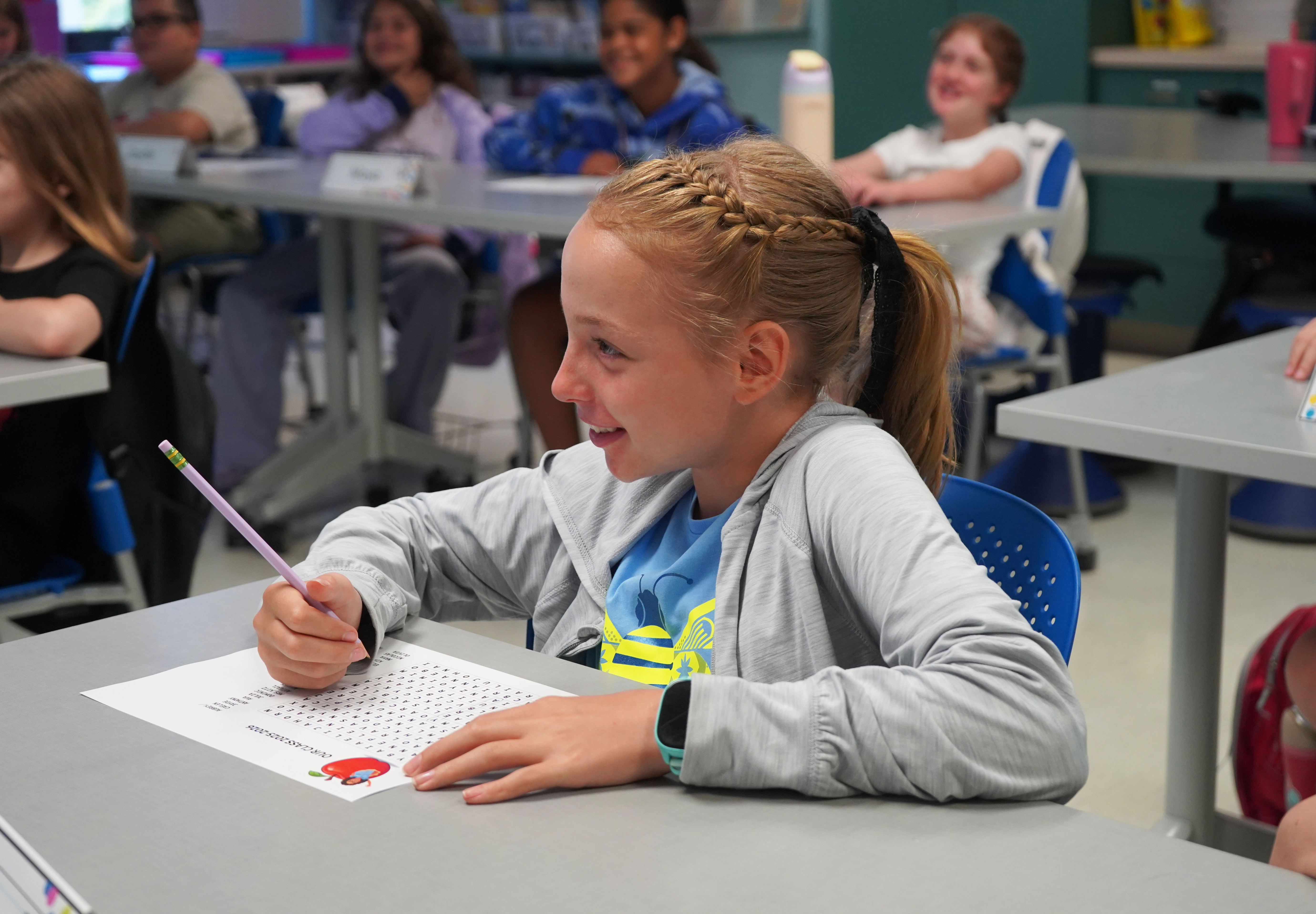 Student sits at a desk.