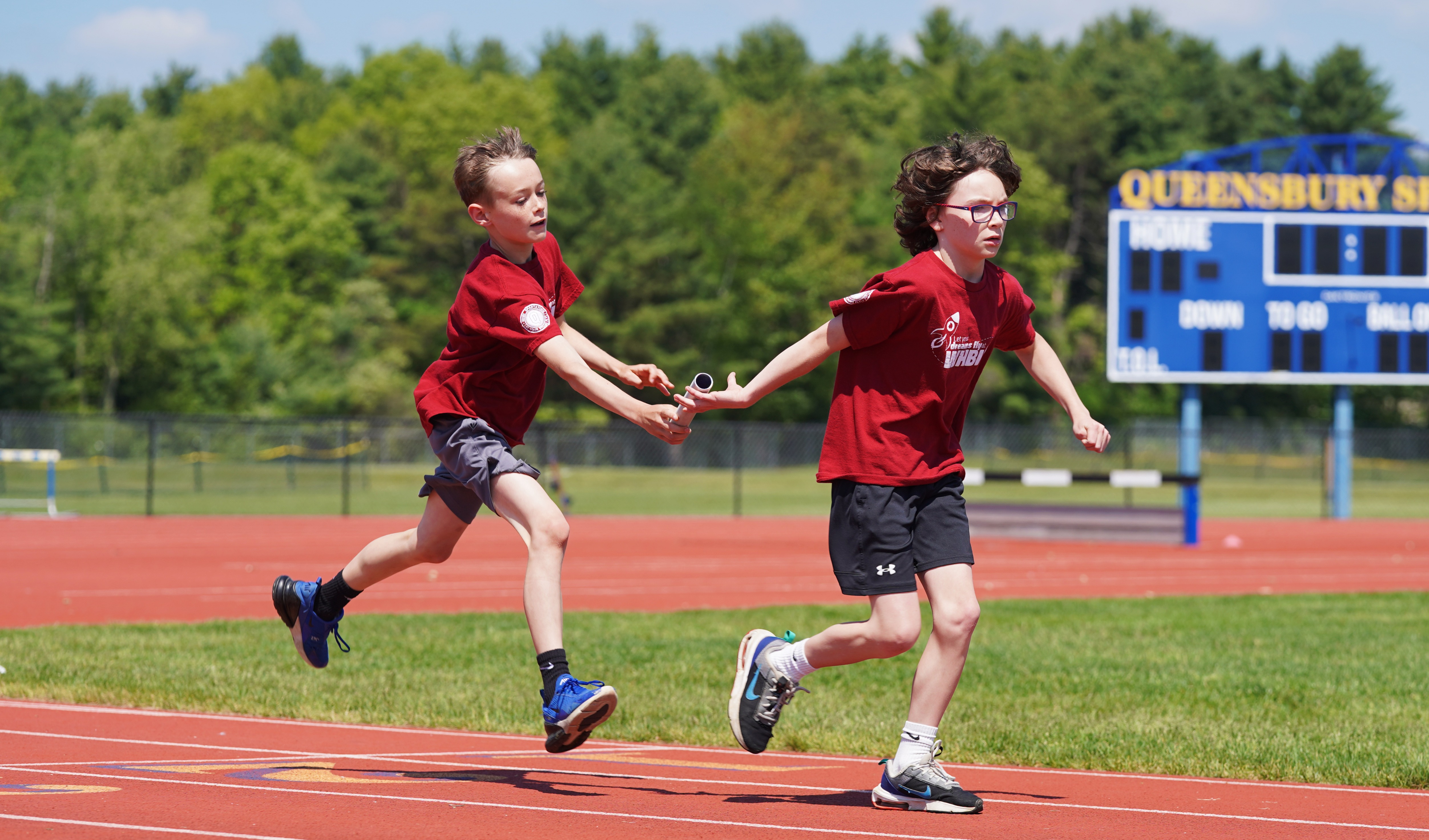 Two students compete in a relay event at Field Day.