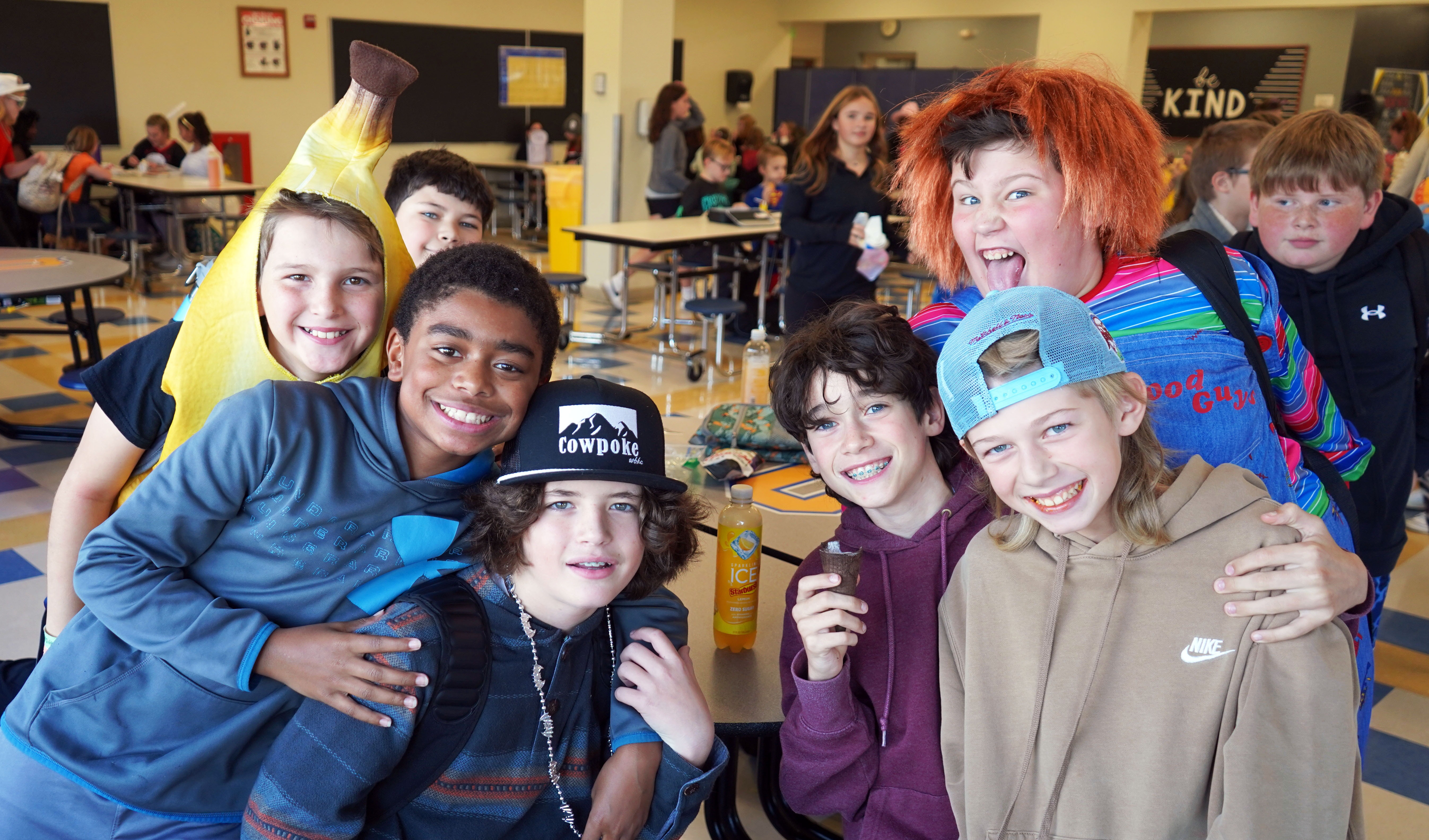 Students stand together on Halloween. 