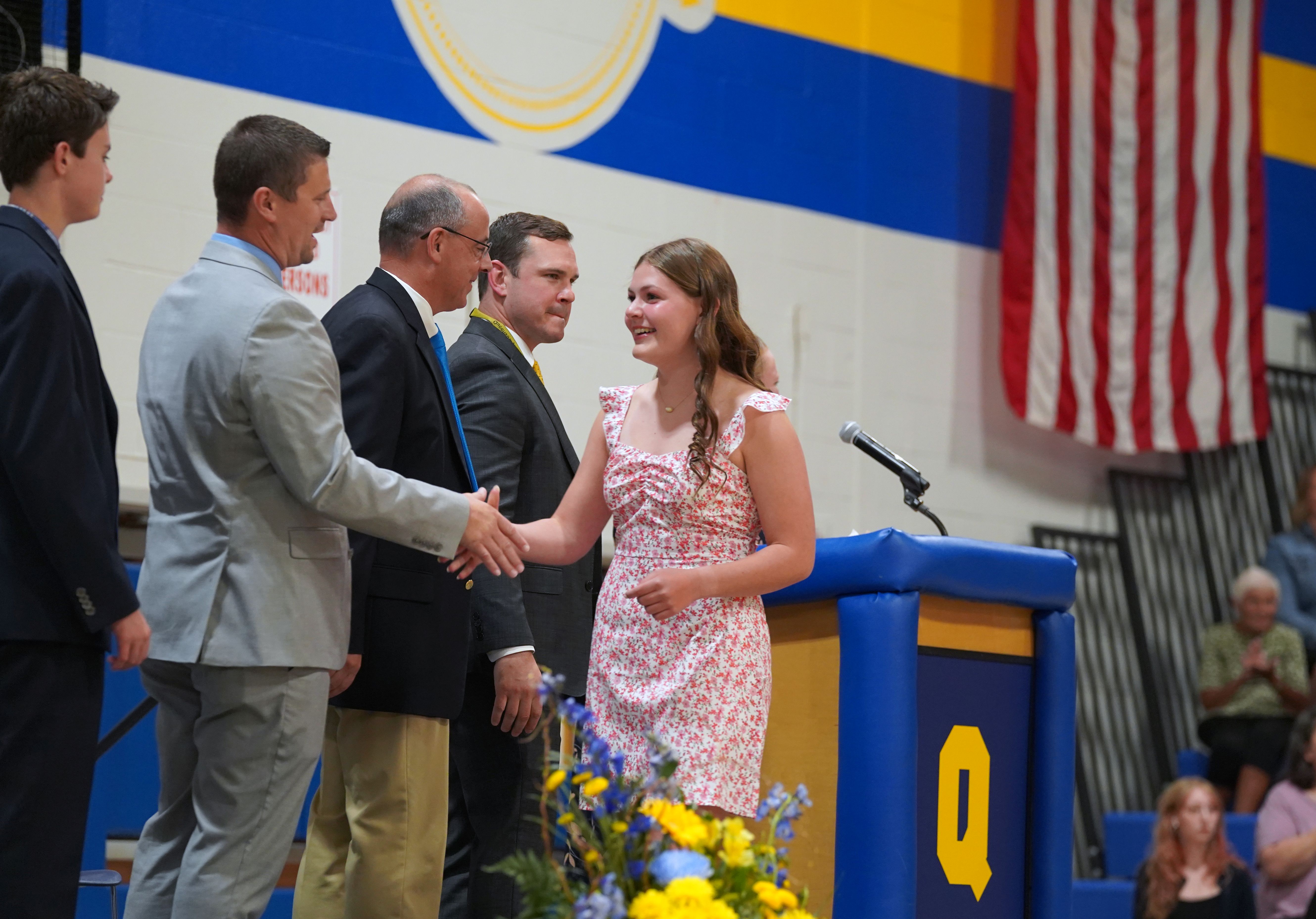Student shakes hand of principal at Moving-Up Ceremony.