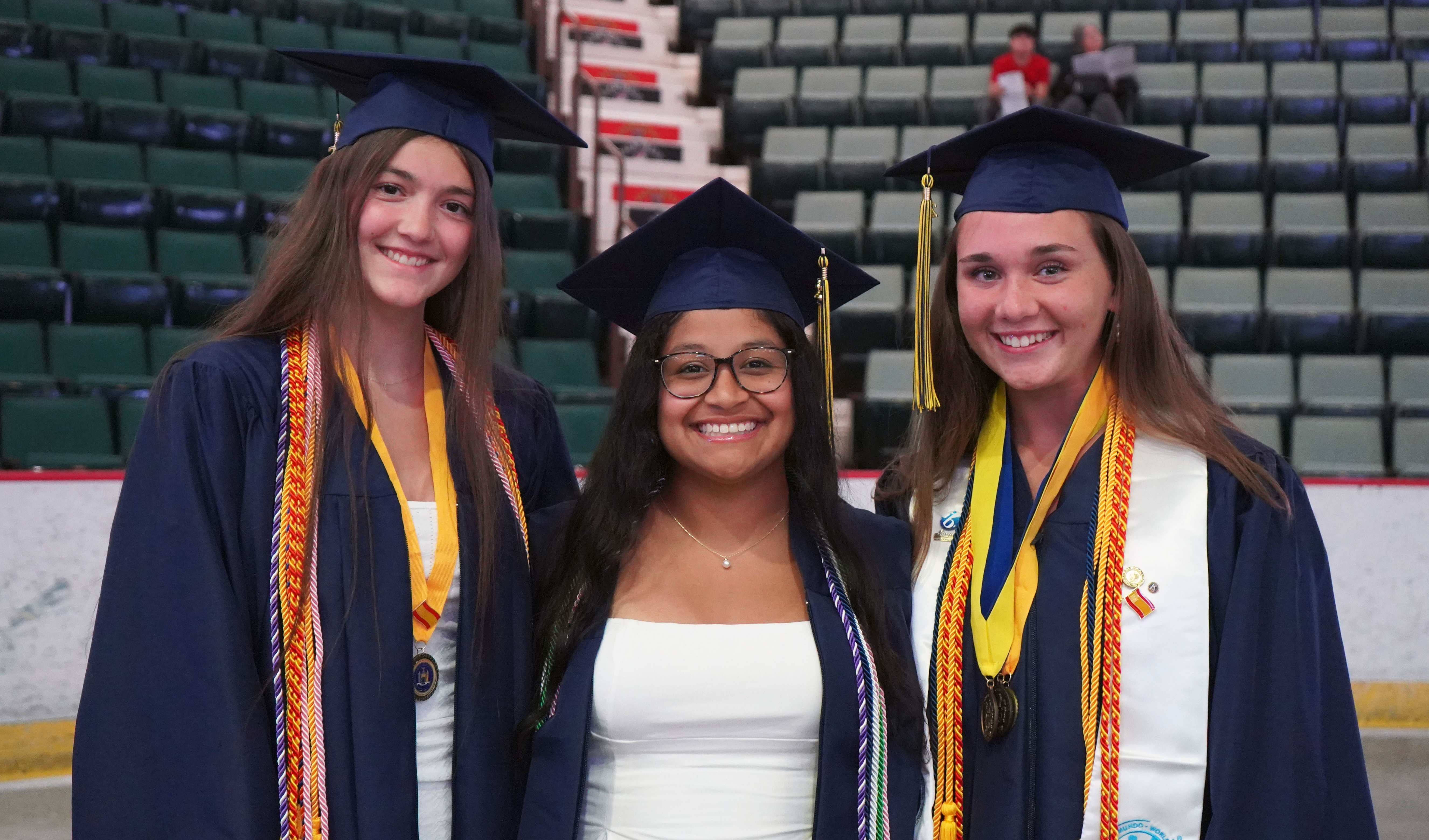 Three students at graduation.