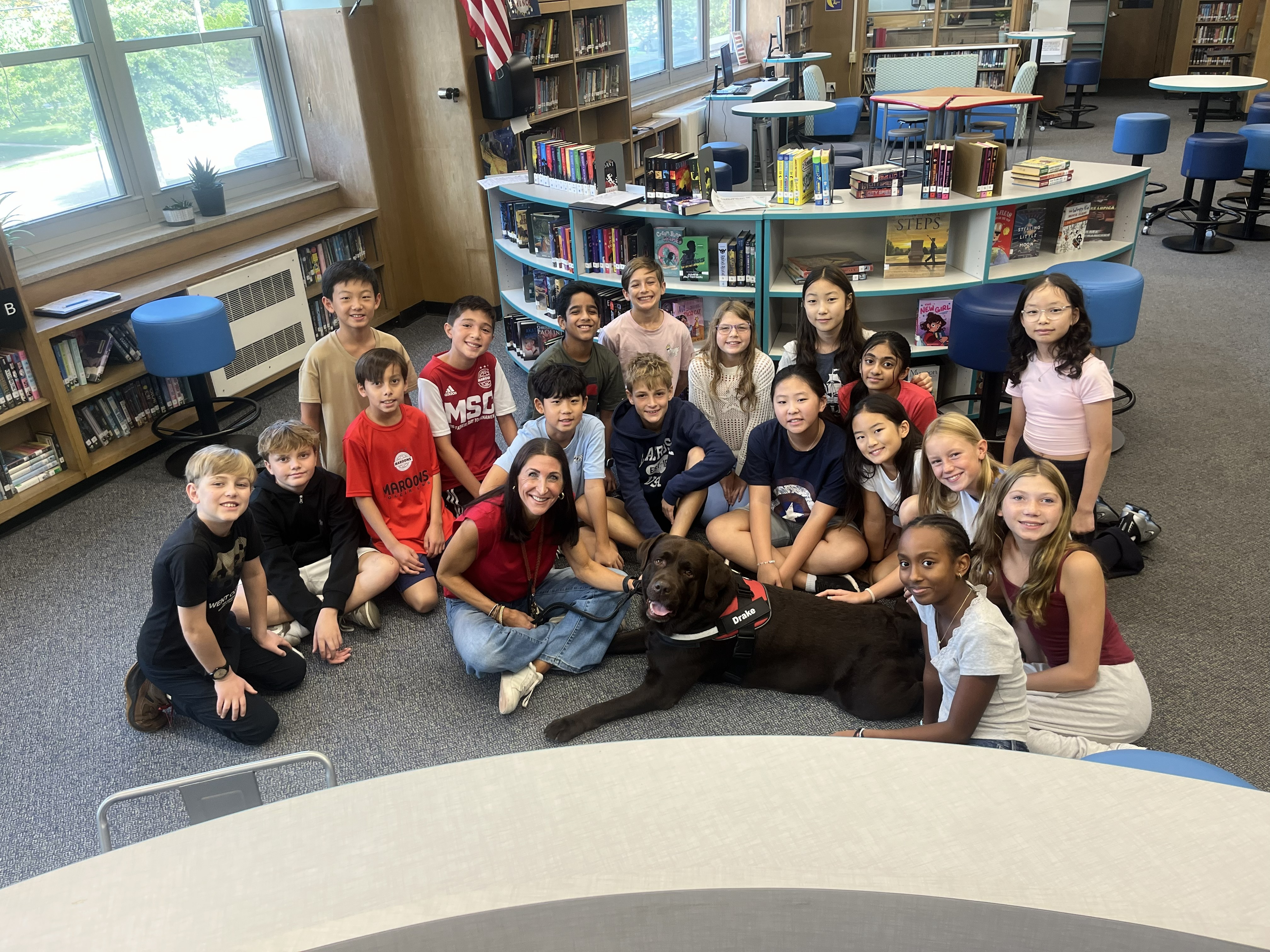 Principal Wisniewski, service dog Drake and students