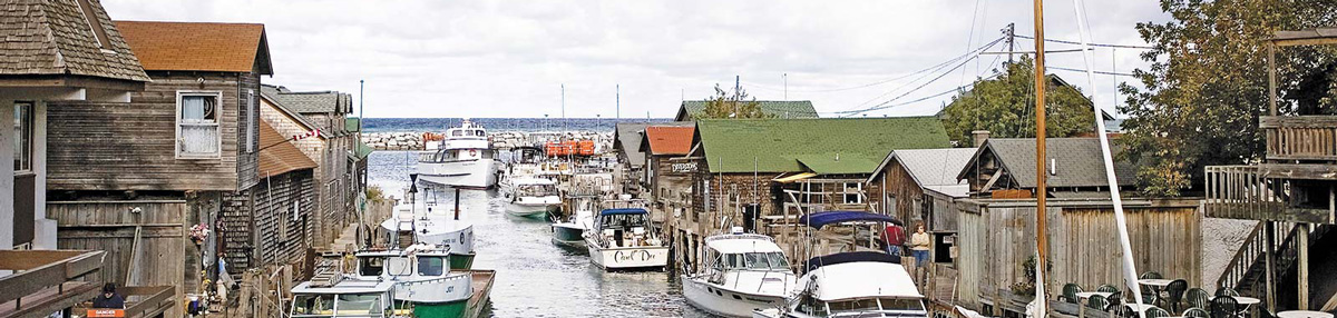 a harbor filled with boats and lined with shops