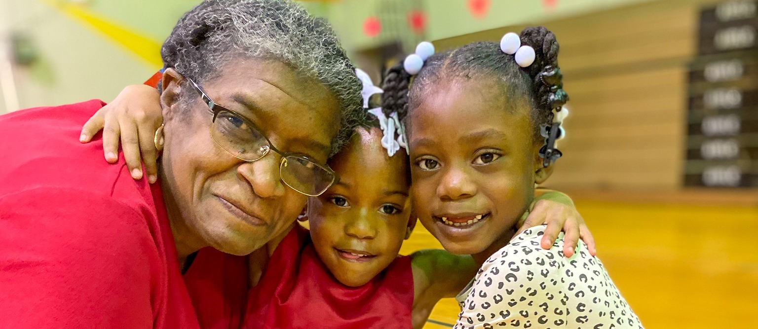 Students and teacher smiling together
