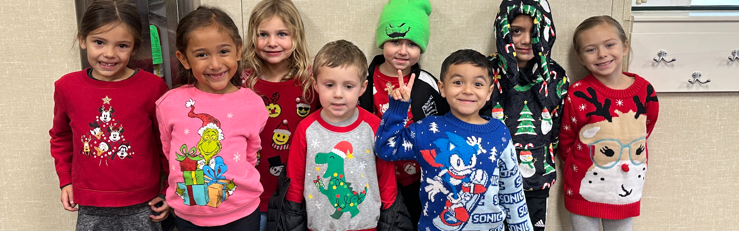 Students wearing Christmas sweaters.