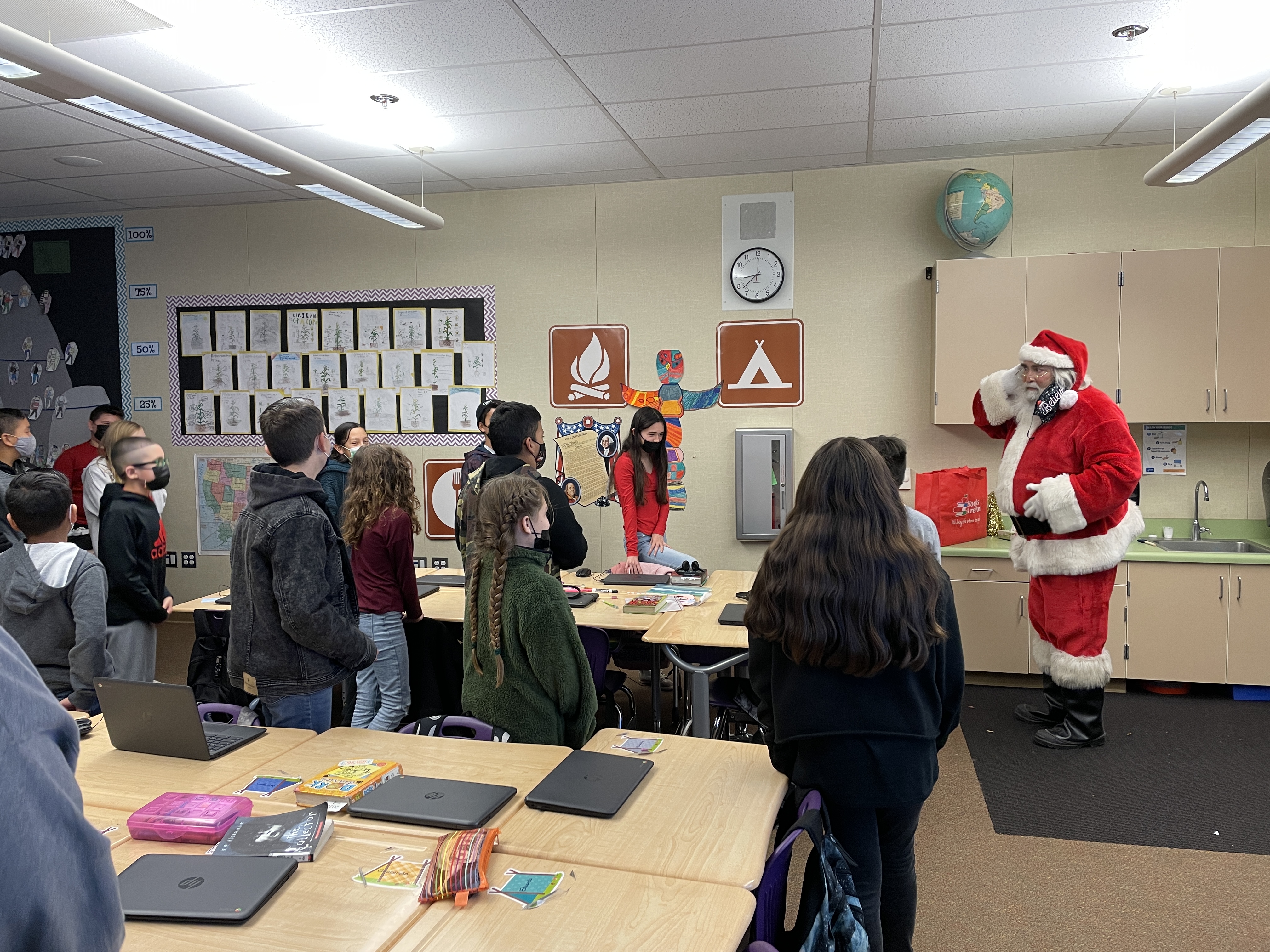 Santa visiting classrooms.